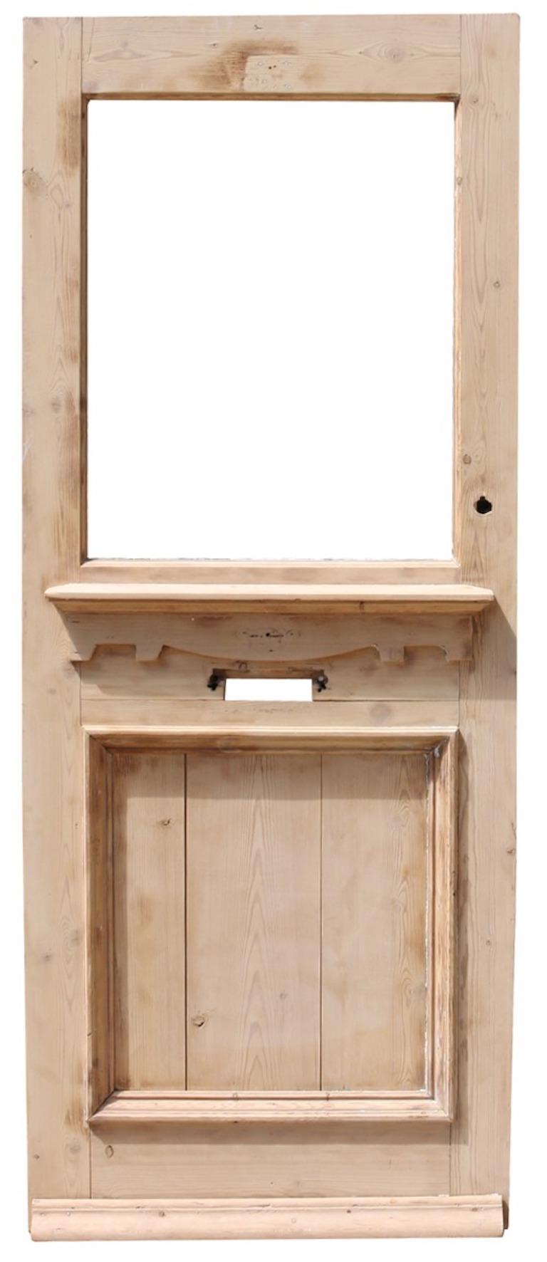 A salvaged front door constructed from pine, for glazing.