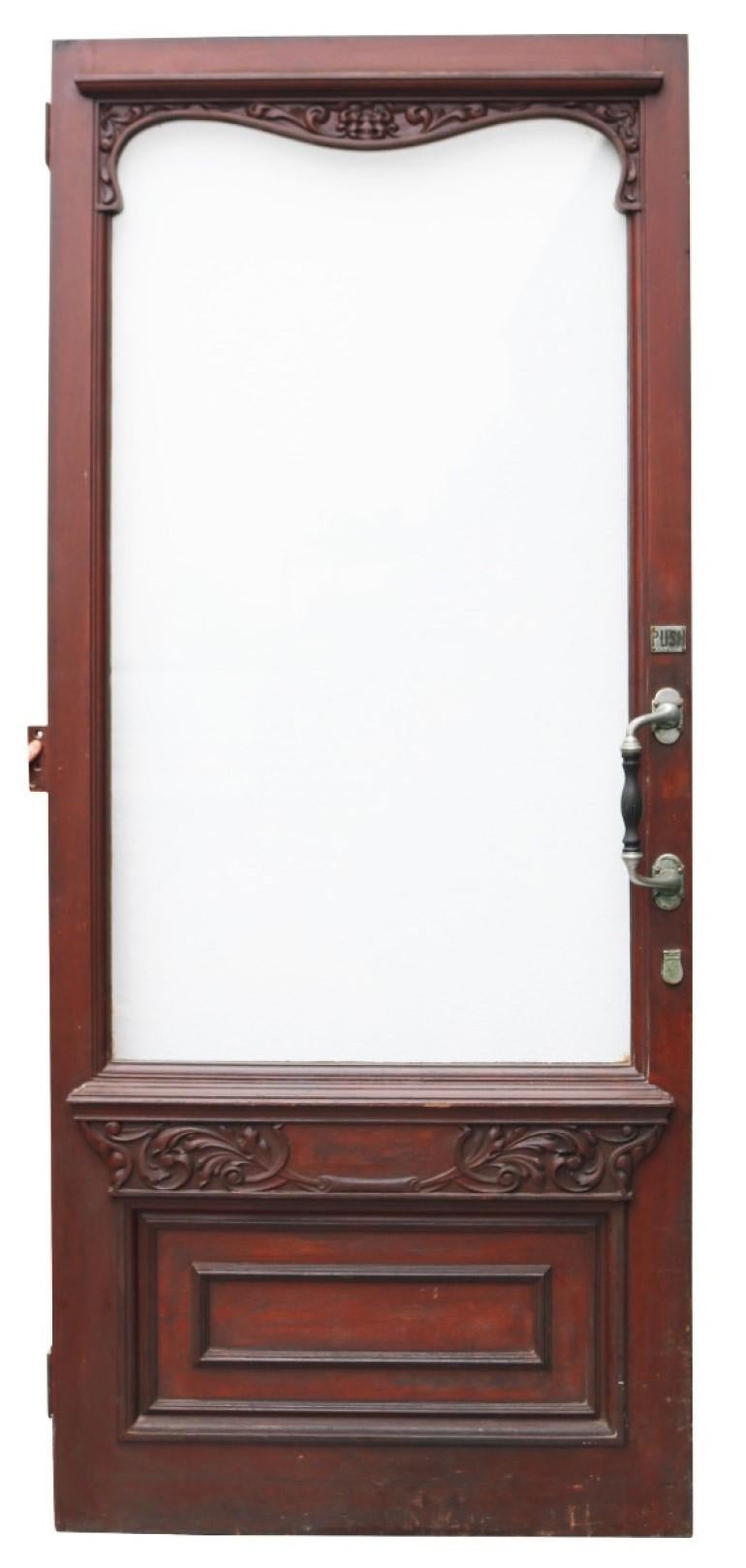 An early 20th century hardwood door with a varnished finish. Suitable as a front door. This comes with its original frame and top light.

Accompanying opening light has number 47 lightly etched on the glass.

This was reclaimed from a shop in