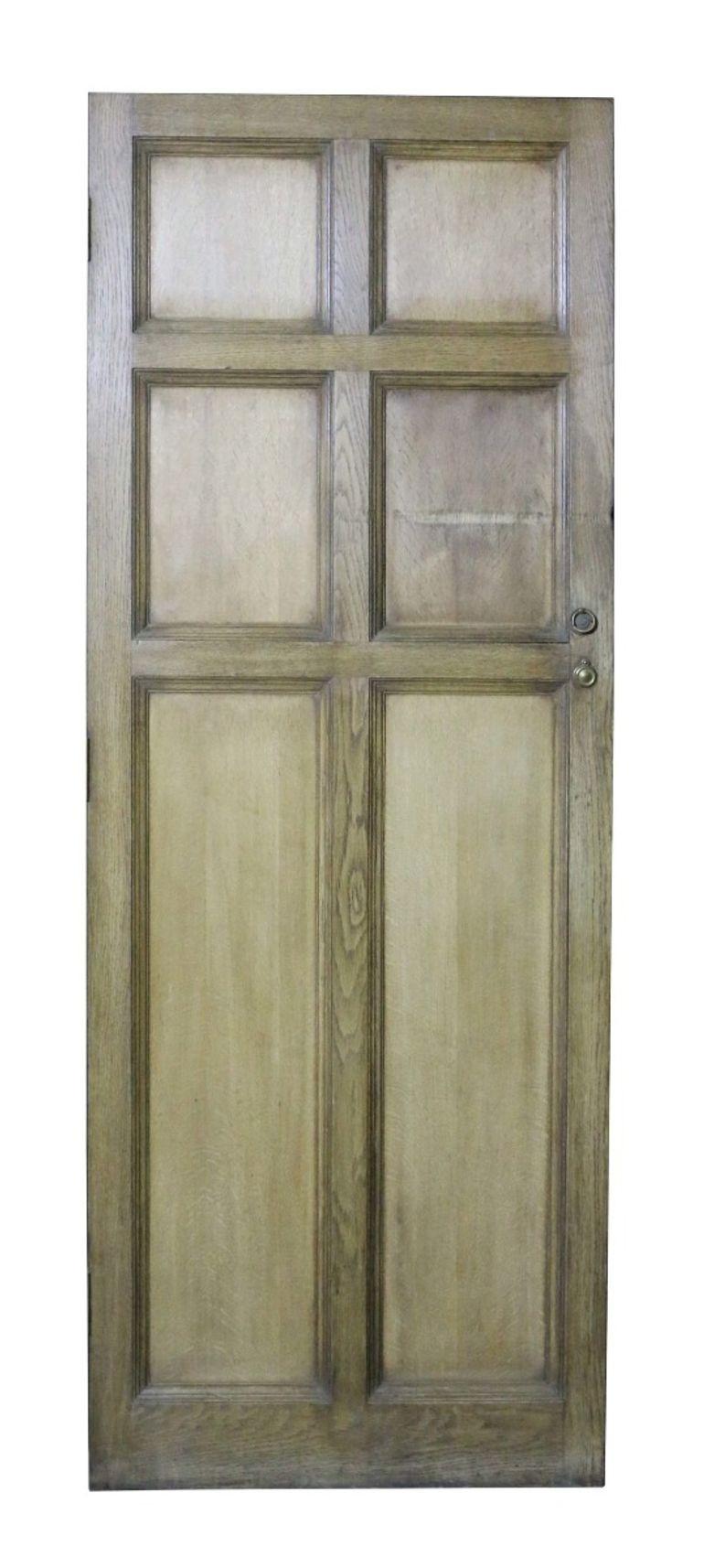 An antique oak door of six panel design.