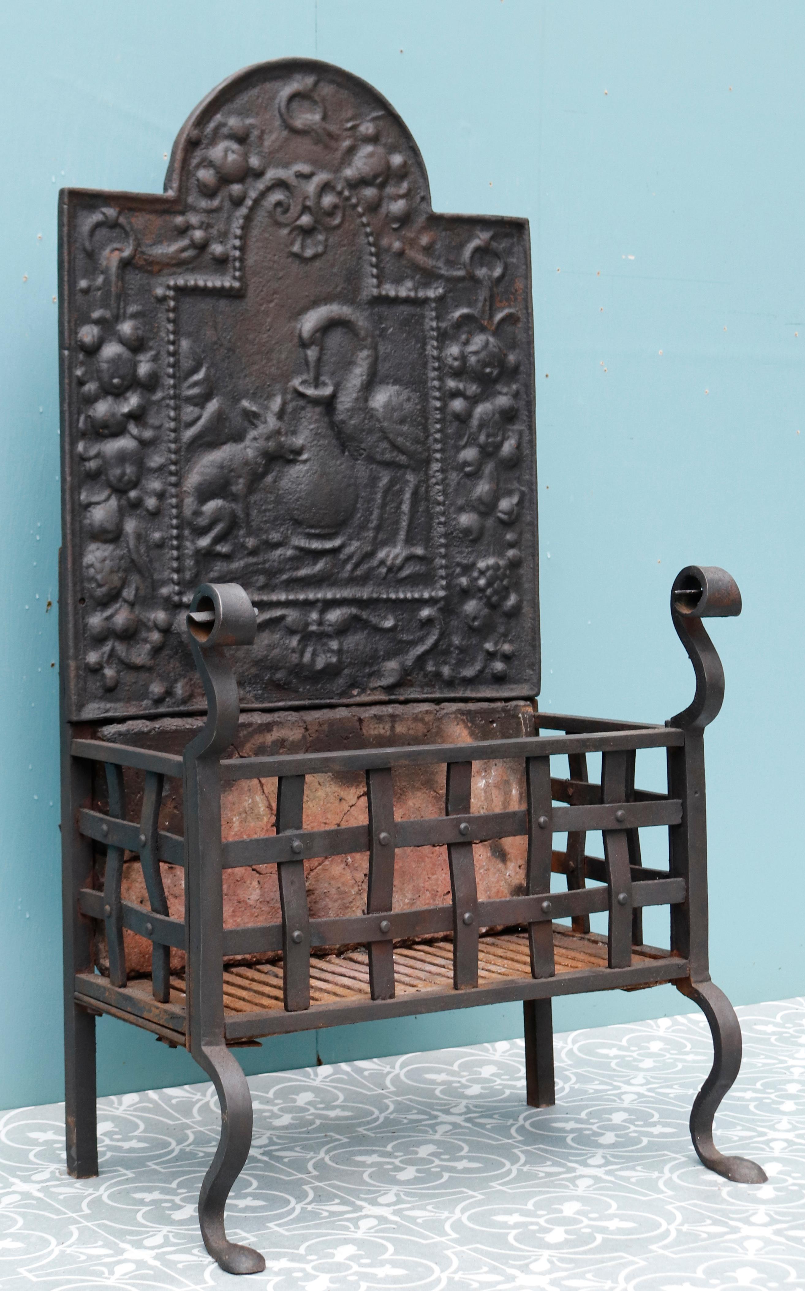 A large antique fire basket constructed from cast and wrought iron. The backplate depicting an Aesops fable scene.