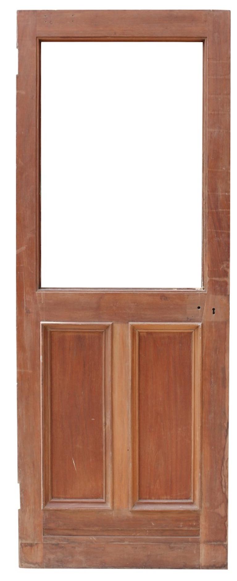 A reclaimed door, constructed from solid walnut, with space for a glazed panel.