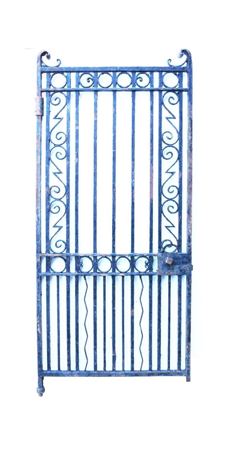 A tall, heavy wrought iron gate, salvaged from a building in central London.