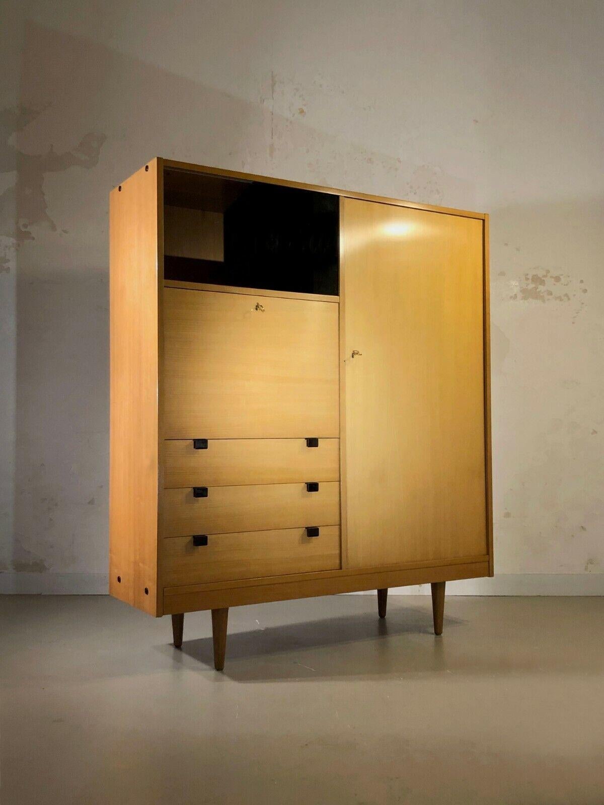 An elegant small wardrobe, Modernist, Bauhaus, Reconstruction, veneer wood structure in clear warm color, a large door opening on the shelving system, with four drawers, one writing desk and shelves with door panels, in the spirit of designs by