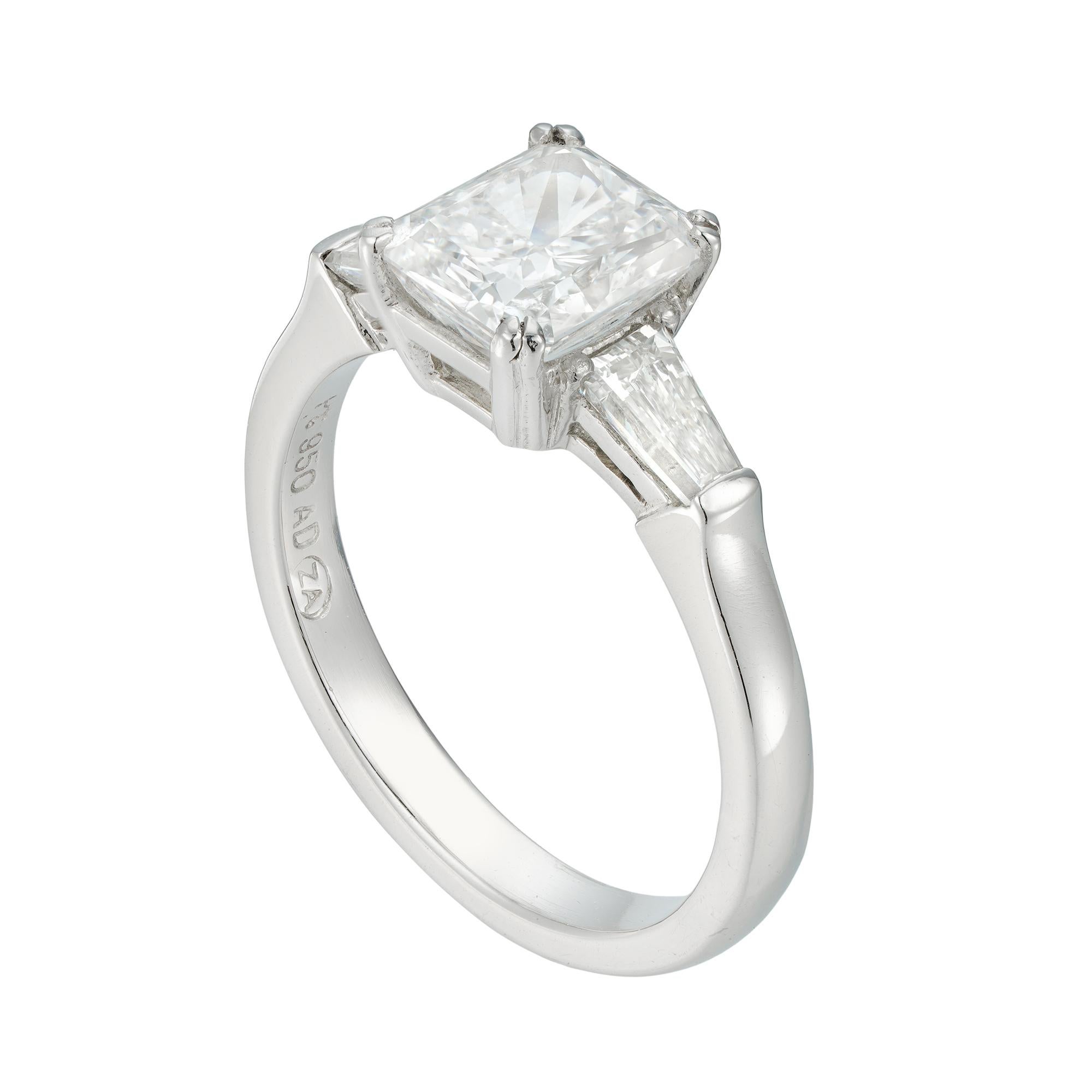 A rectangular brilliant-cut diamond ring, the cut cornered rectangular modified brilliant-cut diamond, accompanied by GIA report stating to be of E colour and SI1 clarity, four double claw-set between two tapered baguette-cut diamonds estimated to