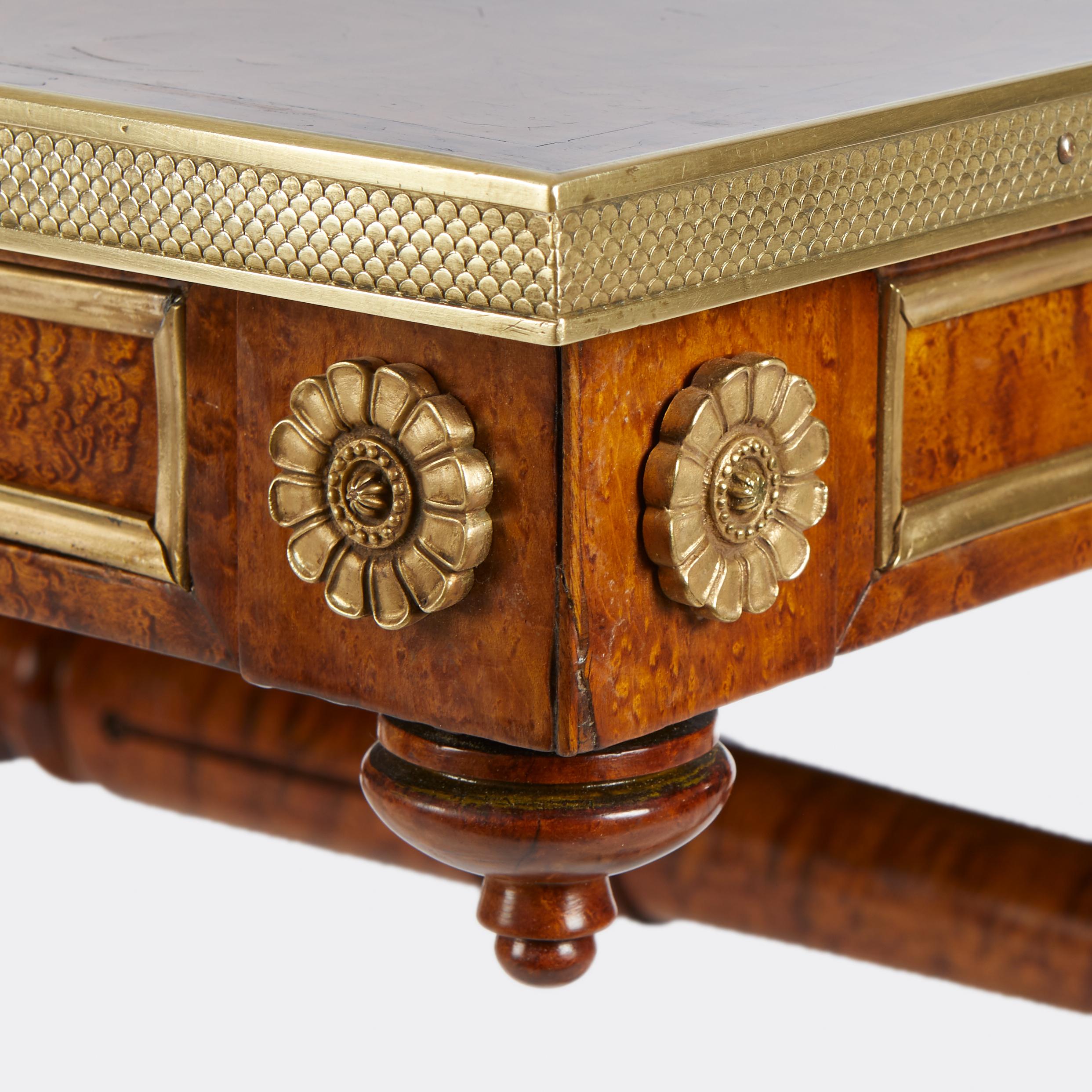 A coffee table with fine marquetry inlaid top, the english regency base is a reduced height and features bronze elements. From the workshops of the London firm Mallet in the 19th century.