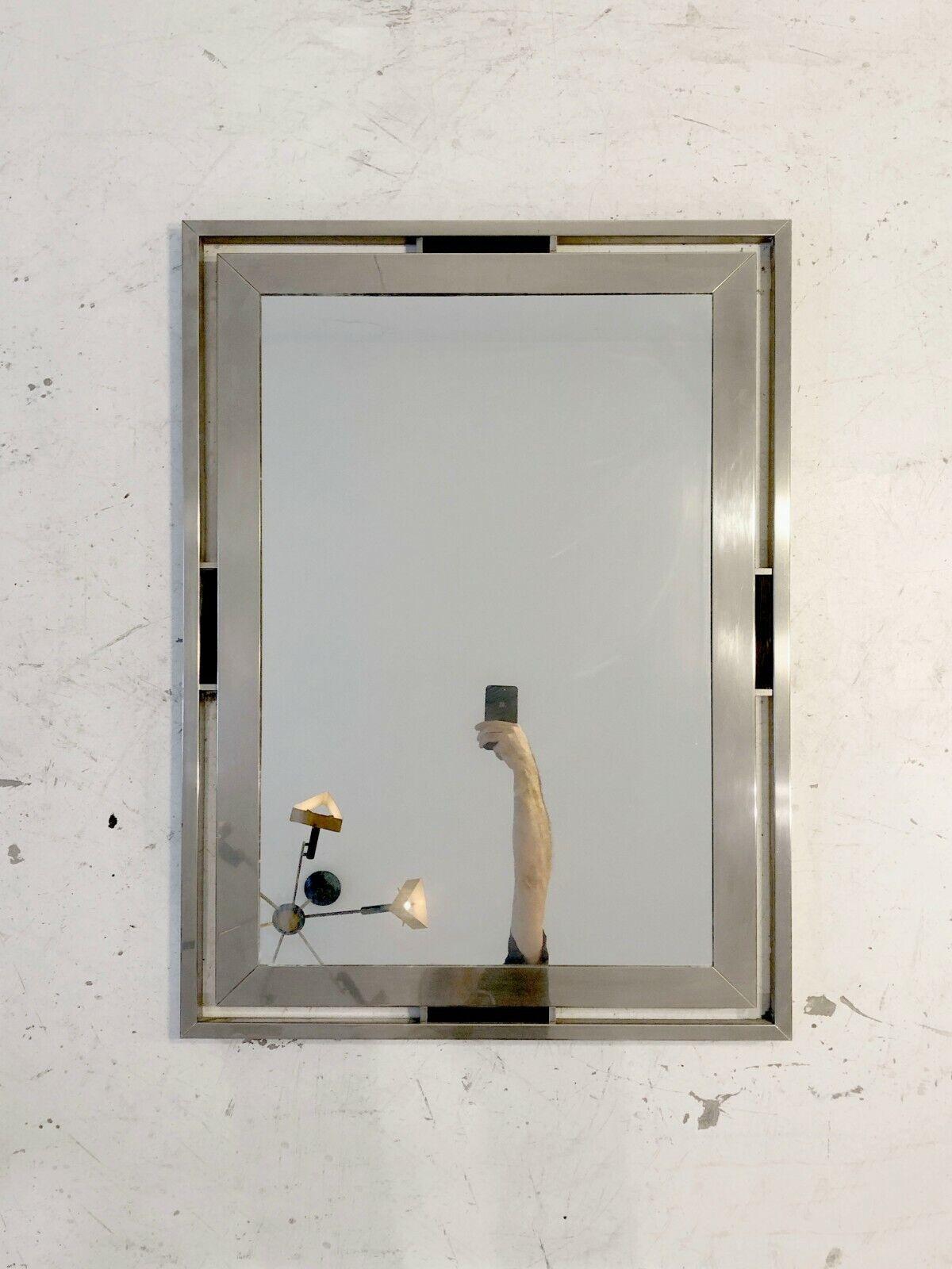 An important rectangular wall mirror, Art-Deco, Modernist, Neo-Classical, with a double frame in brushed steel veneered on a wooden base, linked by 4 elegant and graphic black elements, by Guy Lefevre, Jansen edition, France 1970. 