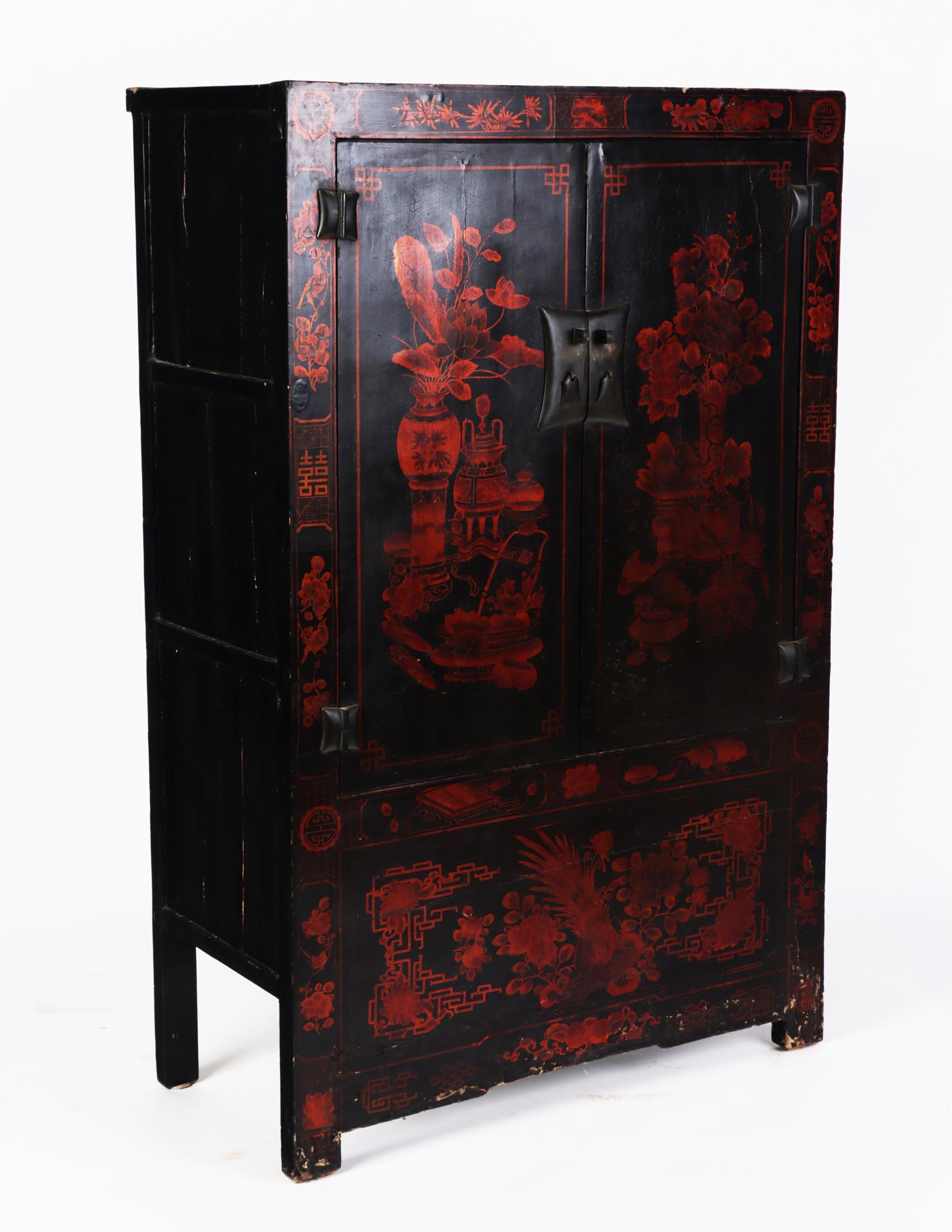 Standalone black lacquered with red ornamentation Chinese cabinet with hand painted landscape, 19th C.
 Single of nineteenth century Chinese wardrobes. Chinoiseries lacquered black paint throughout. 
 This two-section cabinet showcases a two doors