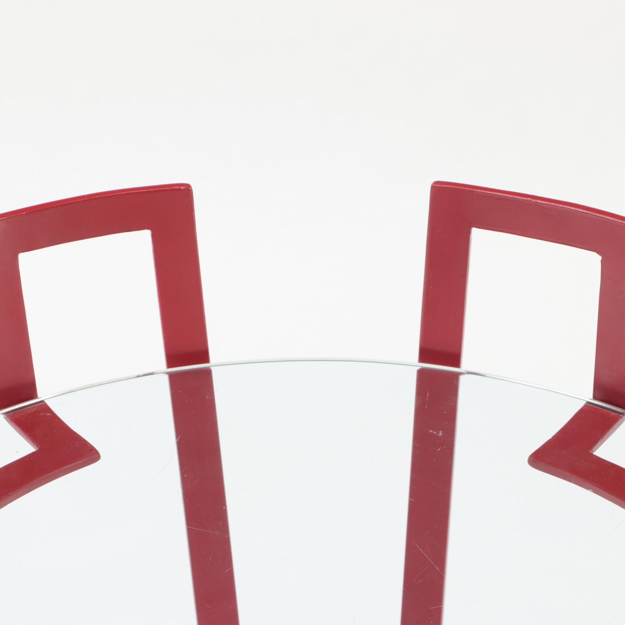 Glass A red iron and glass end table . Contemporary.