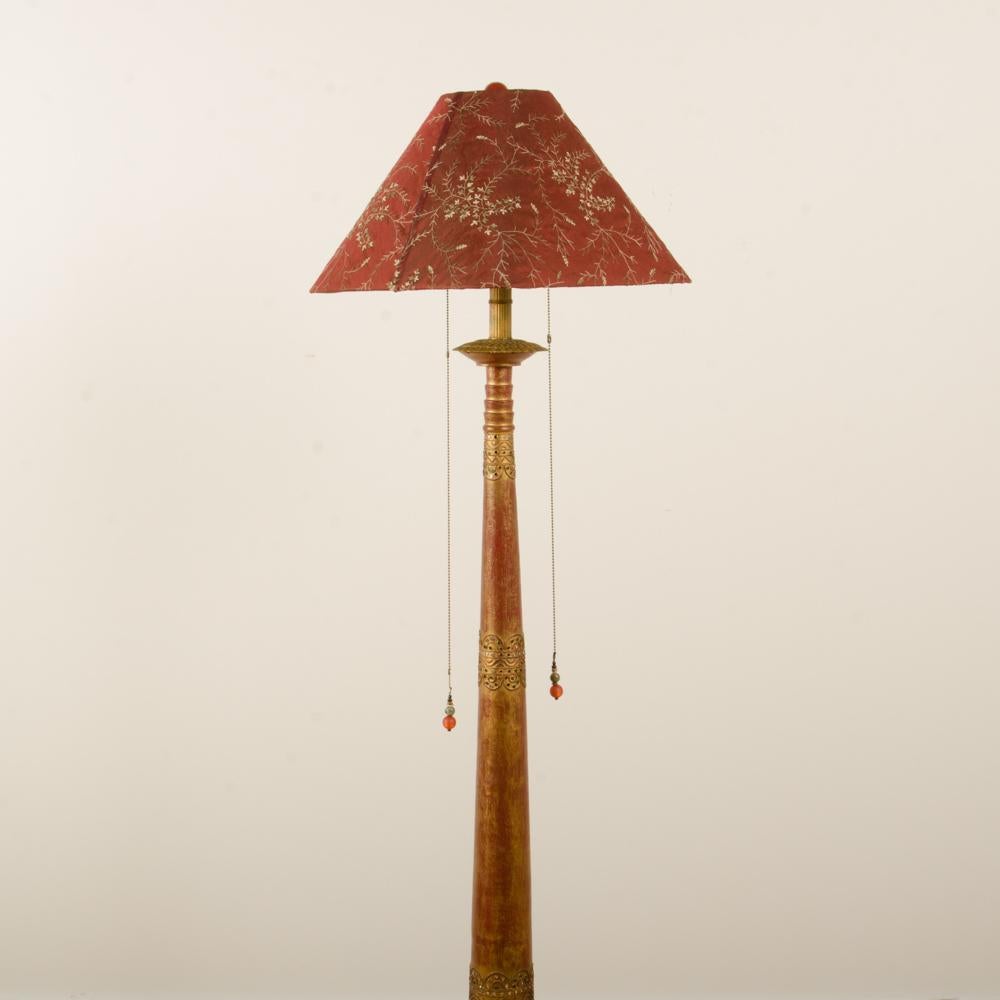 A red painted floor lamp in the manner of Associated Artists, C 1950.
Measure: Base: 12