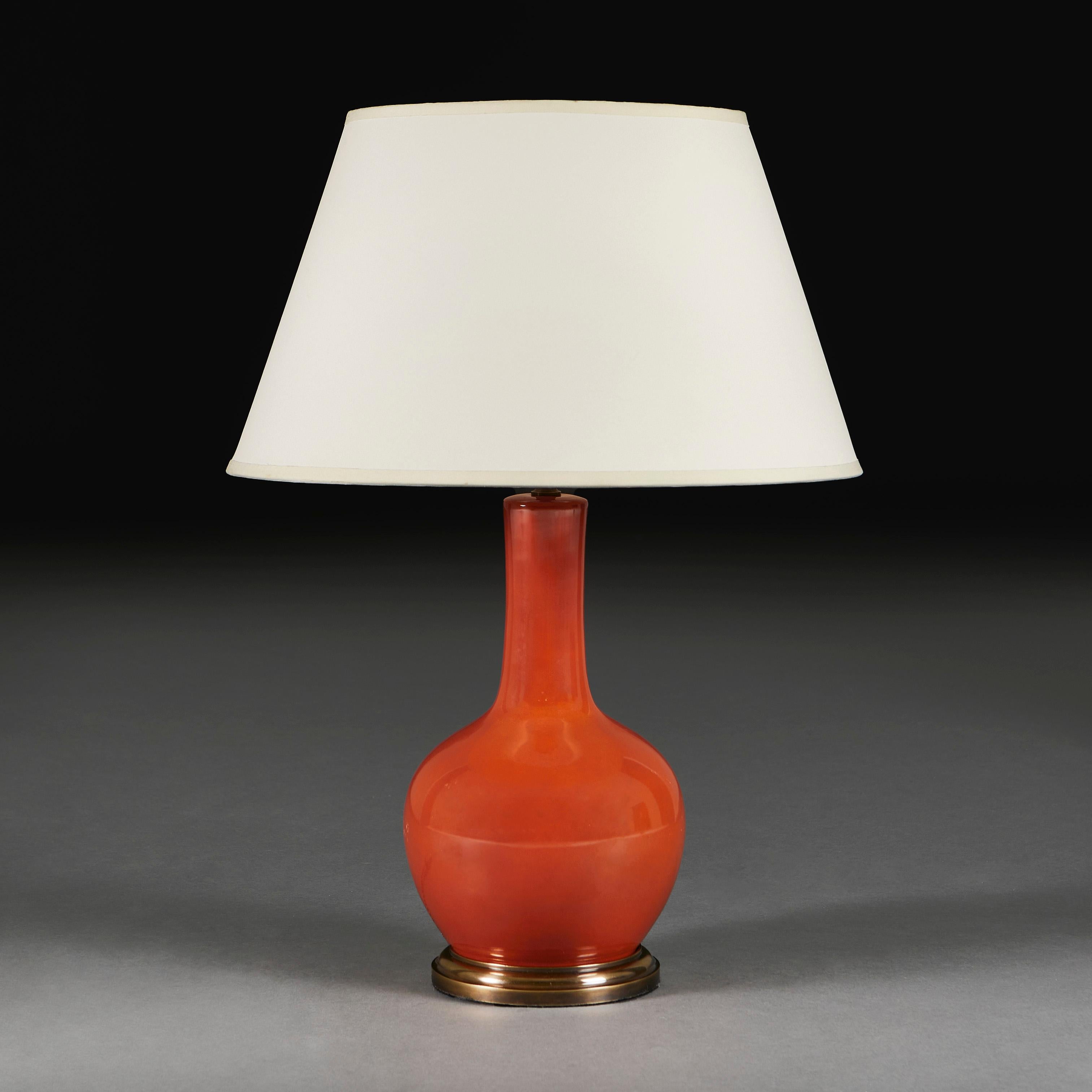 China, circa 1940

A twentieth century Chinese monochrome vase with red umber glaze, of bottle form, now mounted as a lamp on a turned patinated brass base.

Height of vase   32.00cm
Height with lampshade    57.00cm
Diameter of base  