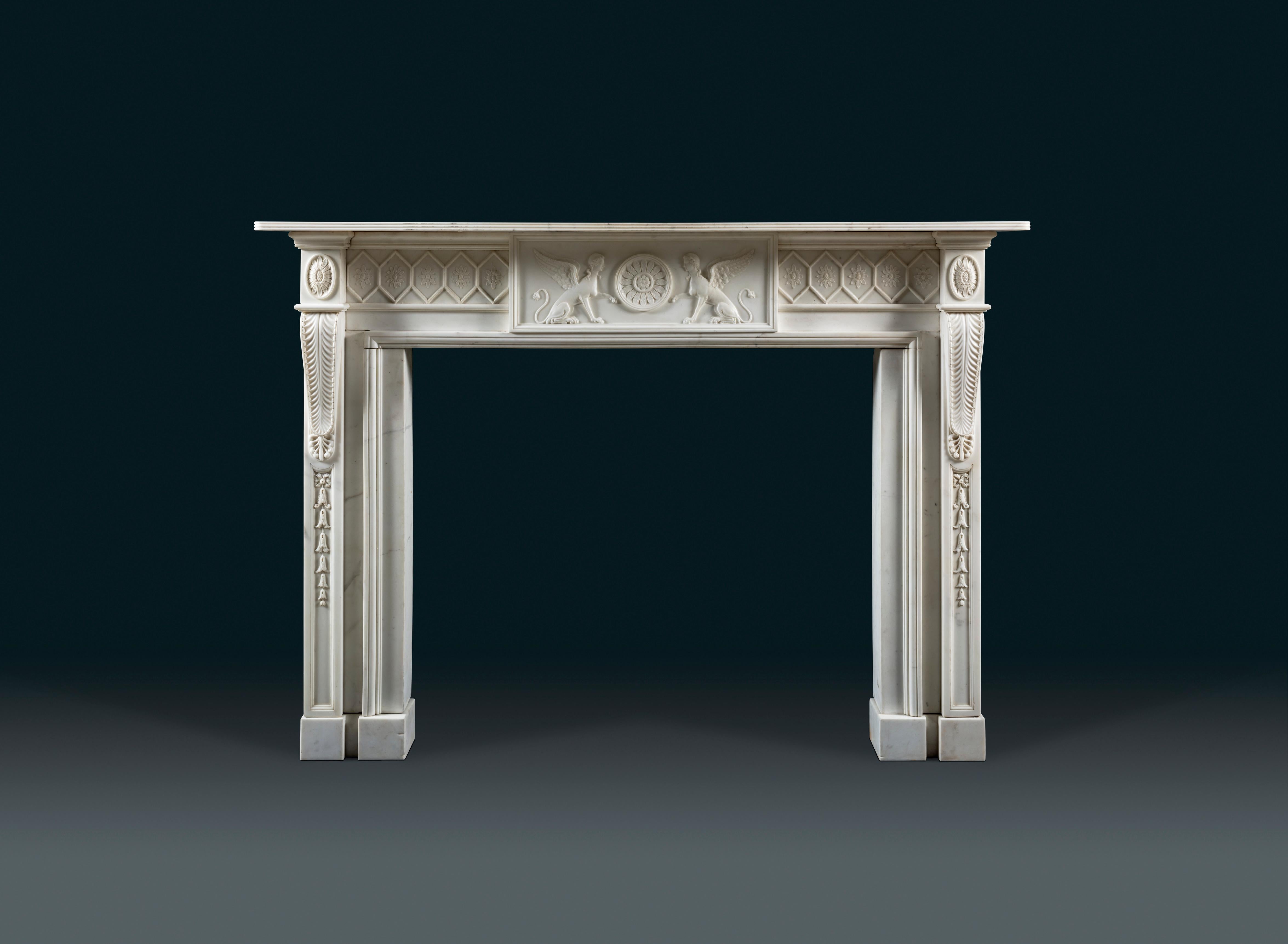 A very refined Adam period chimneypiece carved in white Statuary marble.
The frieze is ornamented with enclosed alternating flowers within lozenge, and with a central tablet depicting two sphinx holding a paterae. The iconography of the sphinx