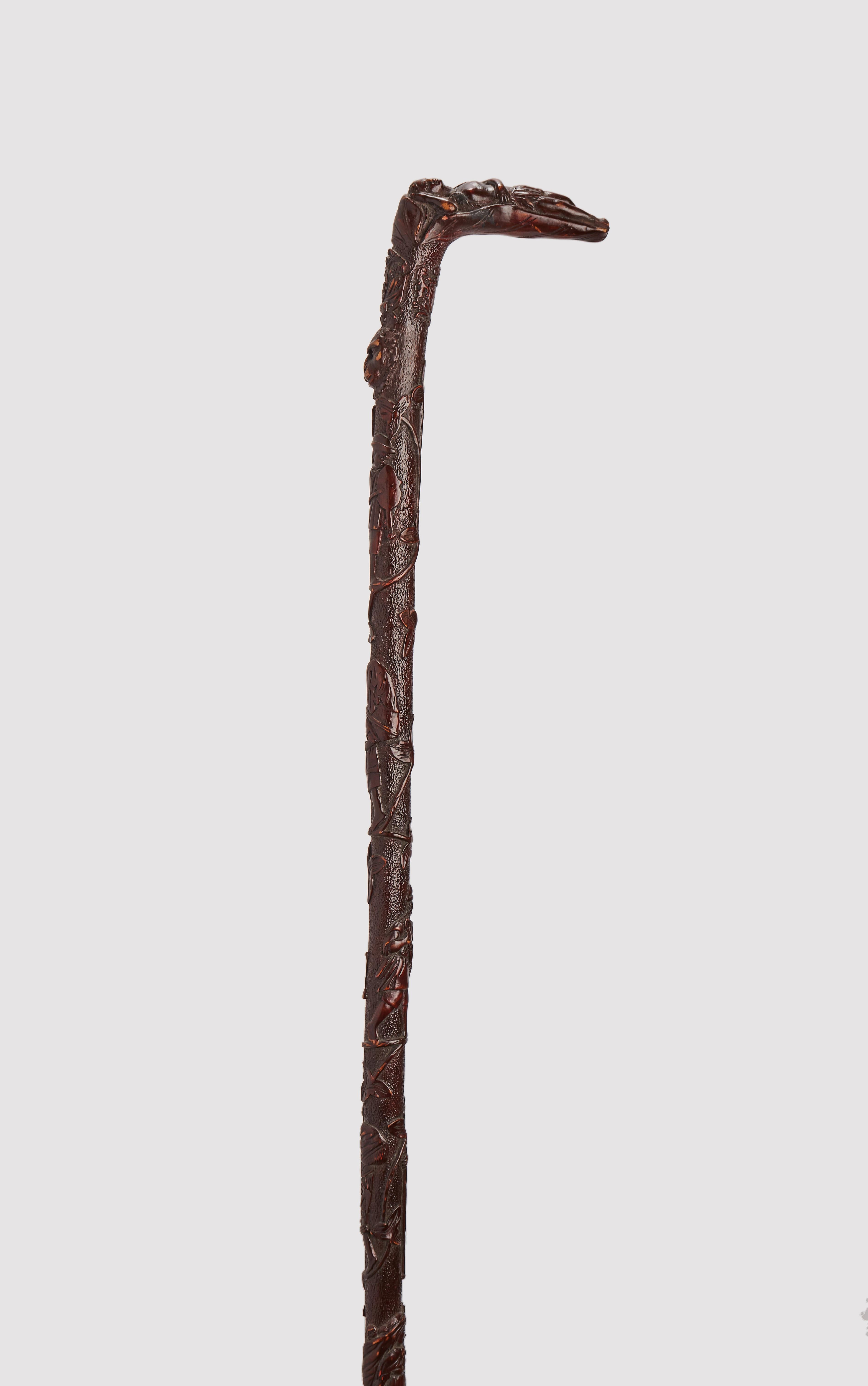 Folk Folk art stick. The barrel is carved and etched from a single branch of Mexican Maple (Acer skutchii) wood and finished with a dark brown patina.
The handle depicts the sculpture of an Indian woman lying down and resting on a sheet of tobacco.
