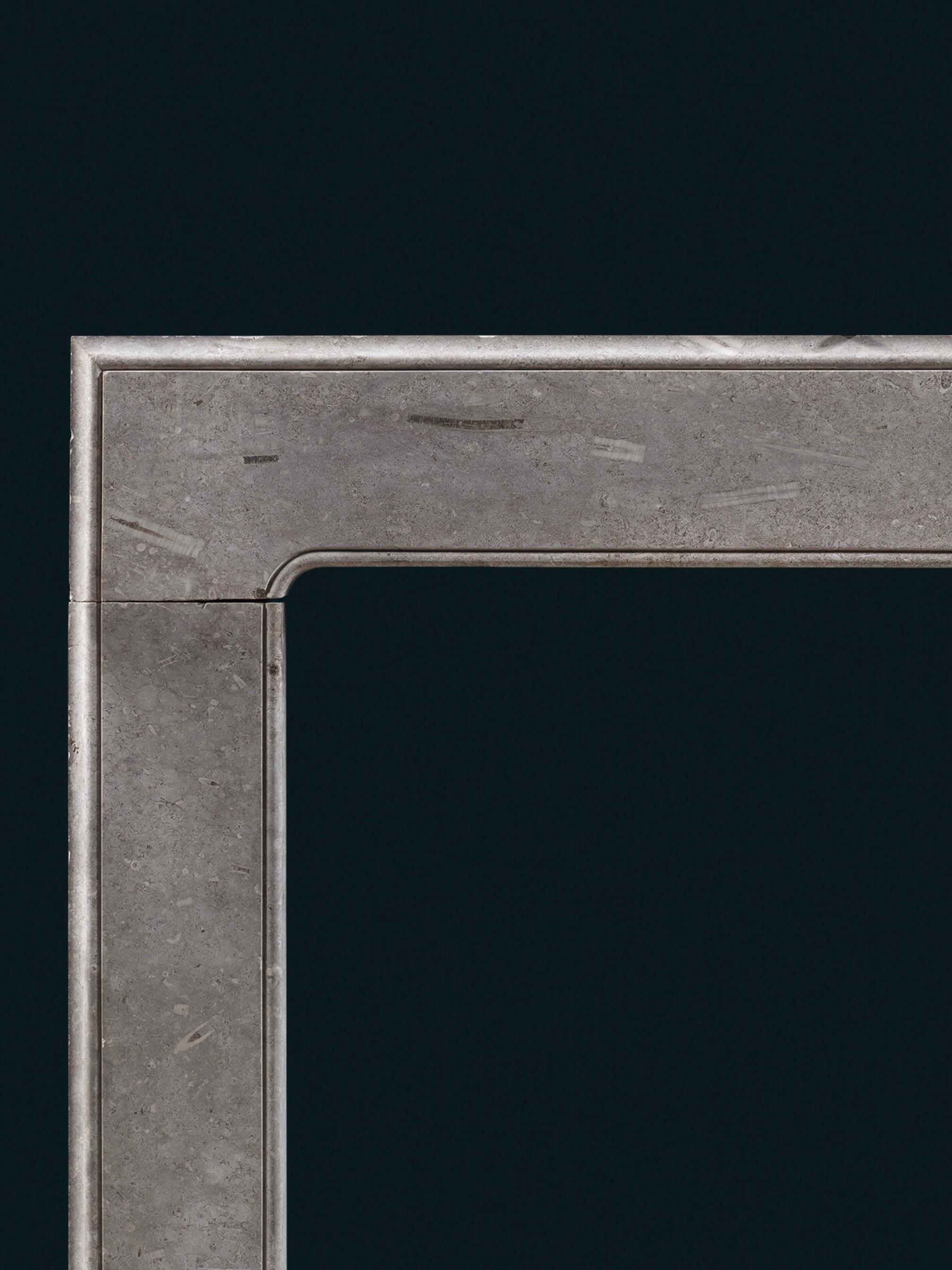 This George I frame chimneypiece is carved from Swaledale marble, a limestone which features an abundance of fossilised remains. The striking crinoids and corals lend the surface depth and texture. The foot blocks are flush with the jambs, their