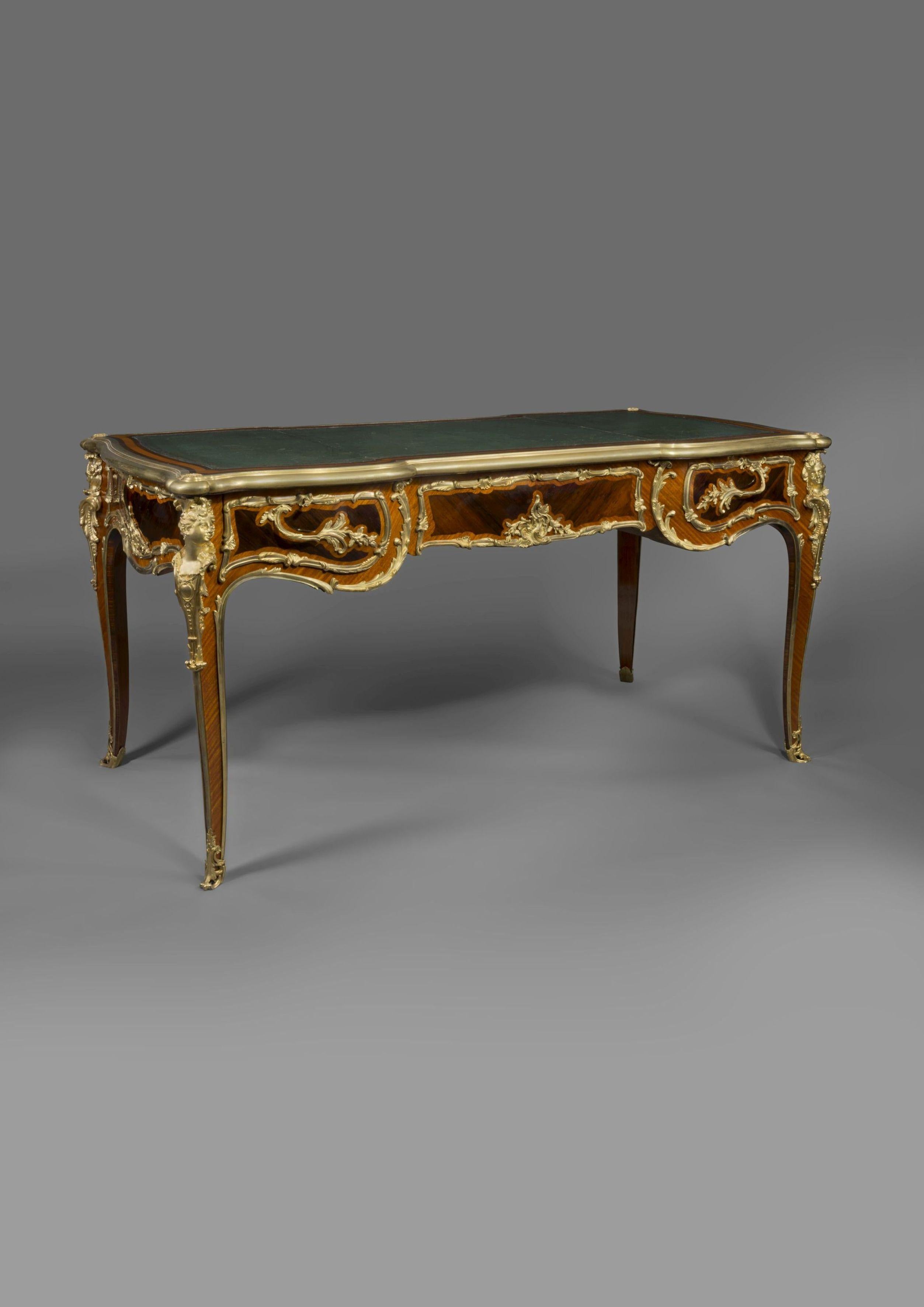 A Regence style gilt bronze-mounted bureau plat by Zwiener.

French, circa 1890. 

Stamped to the reverse of the bronze mounts 'JZ'. 

This fine bureau plat has a shaped leather inset top with gilt-bronze encadrement above three frieze drawers