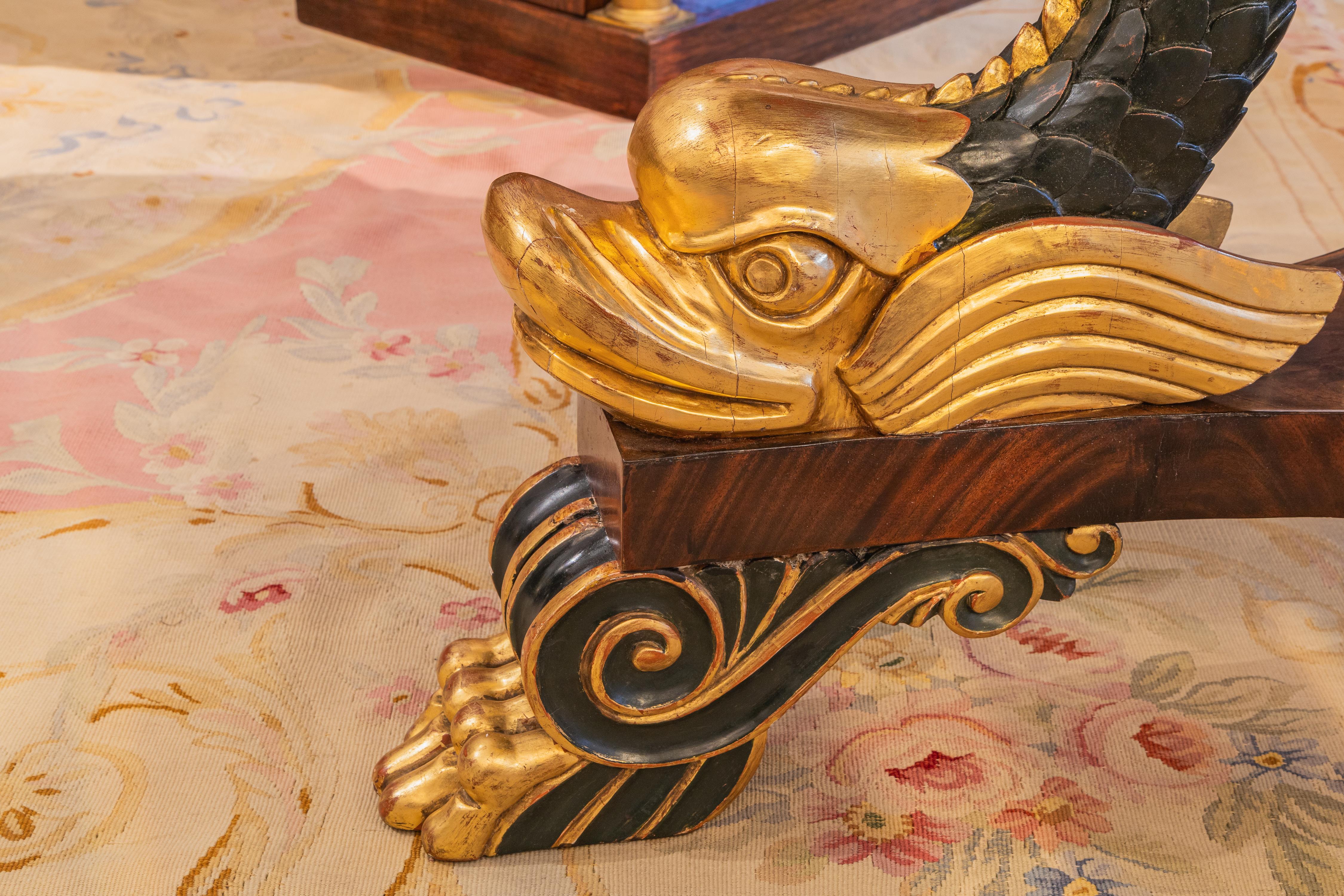 Regency Revival A  Regency  19th c centerhall table . Parcel gilt with a tripod dolphin base For Sale