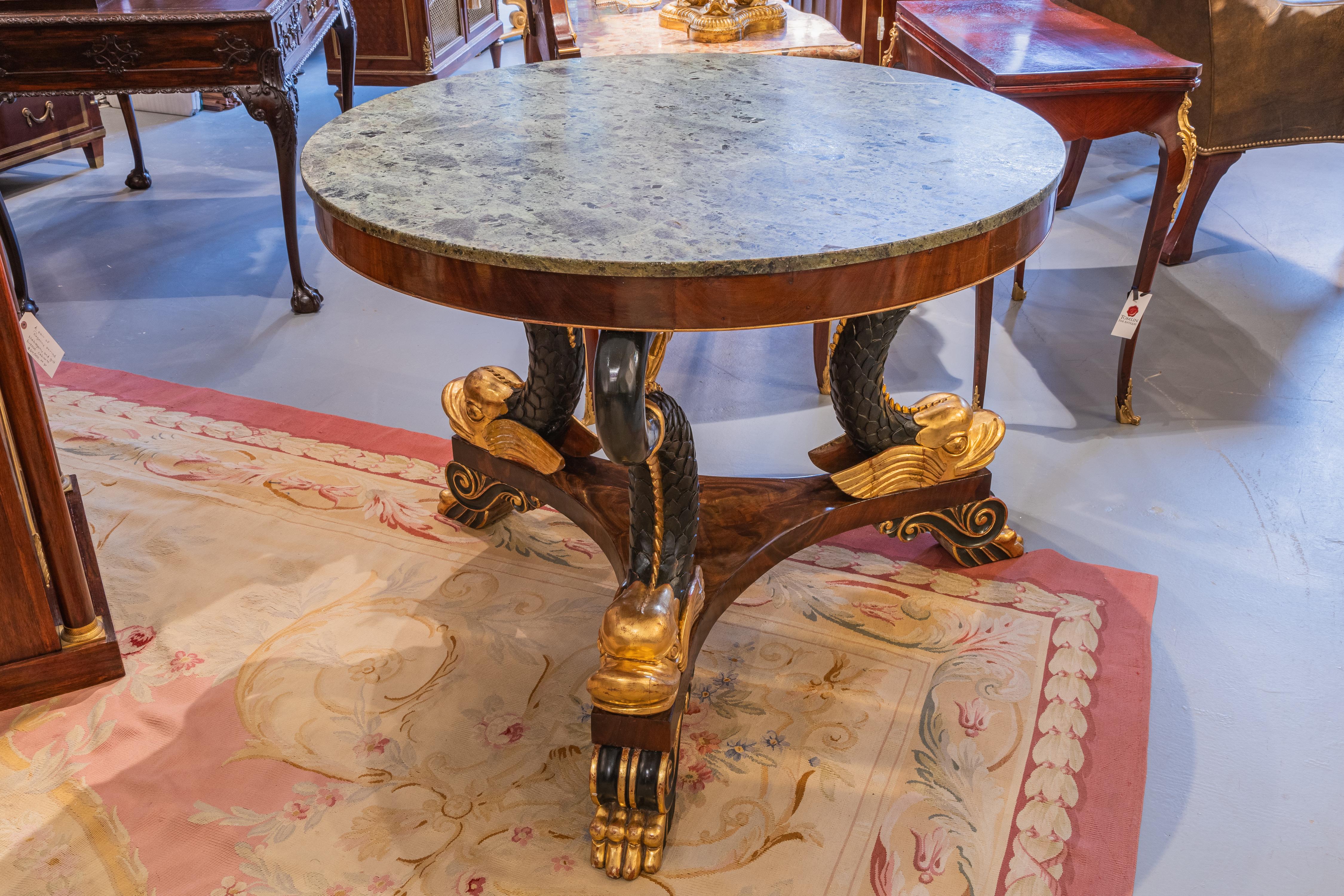 19th Century A  Regency  19th c centerhall table . Parcel gilt with a tripod dolphin base For Sale