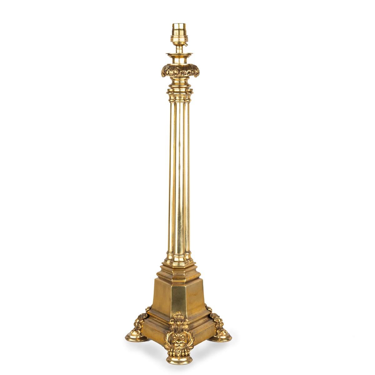 A Regency brass triple column table lamp, comprising a cluster of three classical columns set on a pyramidal base with lion’s mask-and-paw feet, rewired for electricity.  English, circa 1815.



Height to top of fitting 23 ½ inches Diameter 8 inches