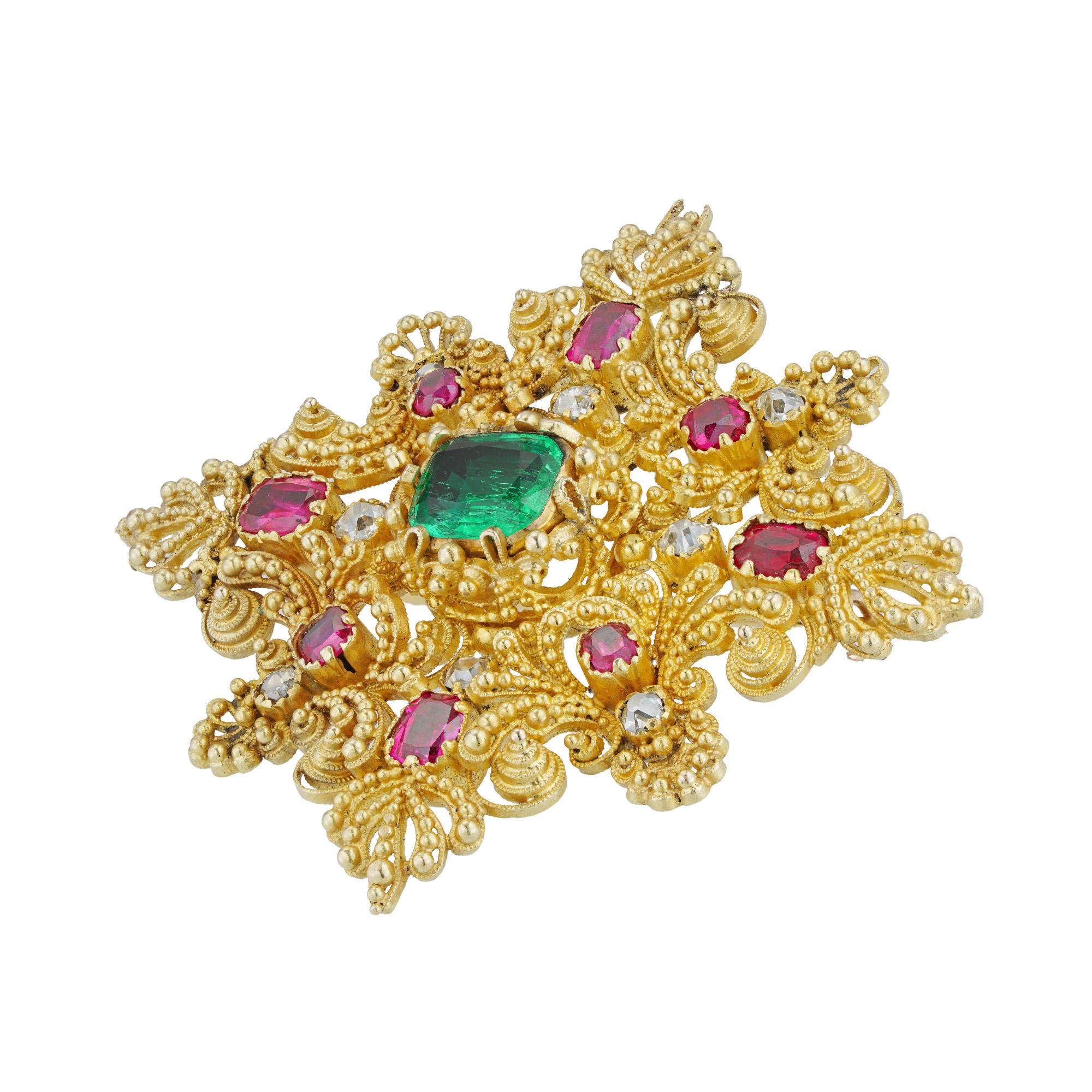 A Regency cannetille gem-set cross brooch, to the centre a rectangular-cut emerald estimated to weigh 0.9 carats, surrounded by eight rectangular-cut rubies and eight old mine-cut diamonds, the rubies estimated to weigh 0.6 carats in total and the