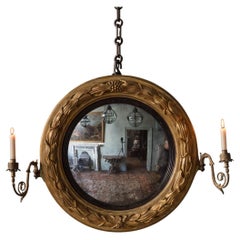 Miroir convexe en bois doré sculpté de style Régence
