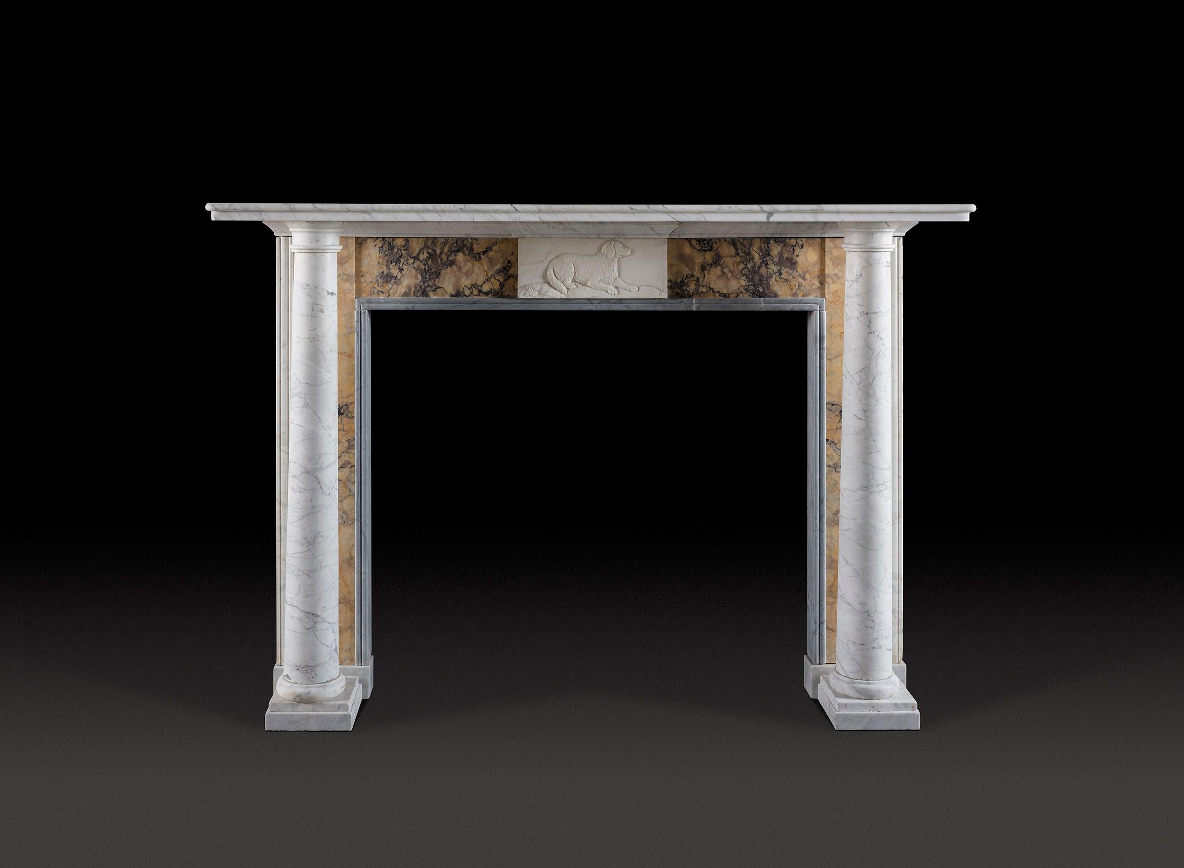 An early 19th century chimneypiece with free-standing Doric columns supporting a simple moulded shelf, a Bardiglio double moulding framing the opening and a central tablet of a water spaniel carved in white marble.

Measurements: 
Height 46½in