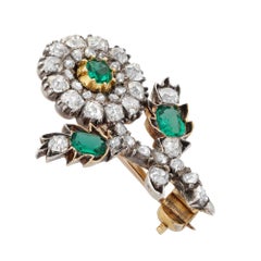 A Regency emerald and diamond flower brooch