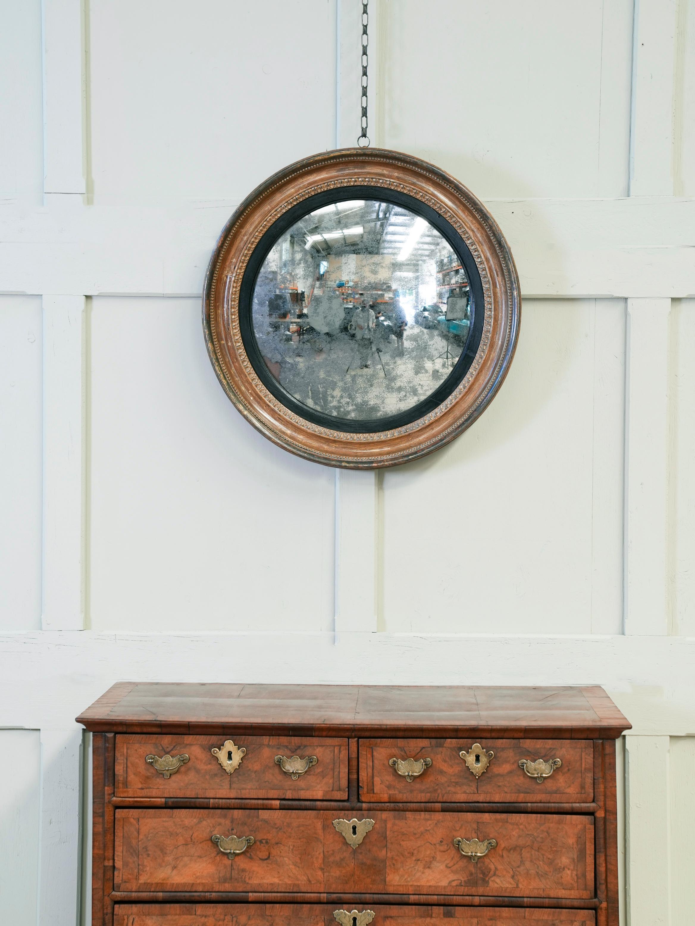 The carved timber frame with original gilding, distressed original mercury plate.

