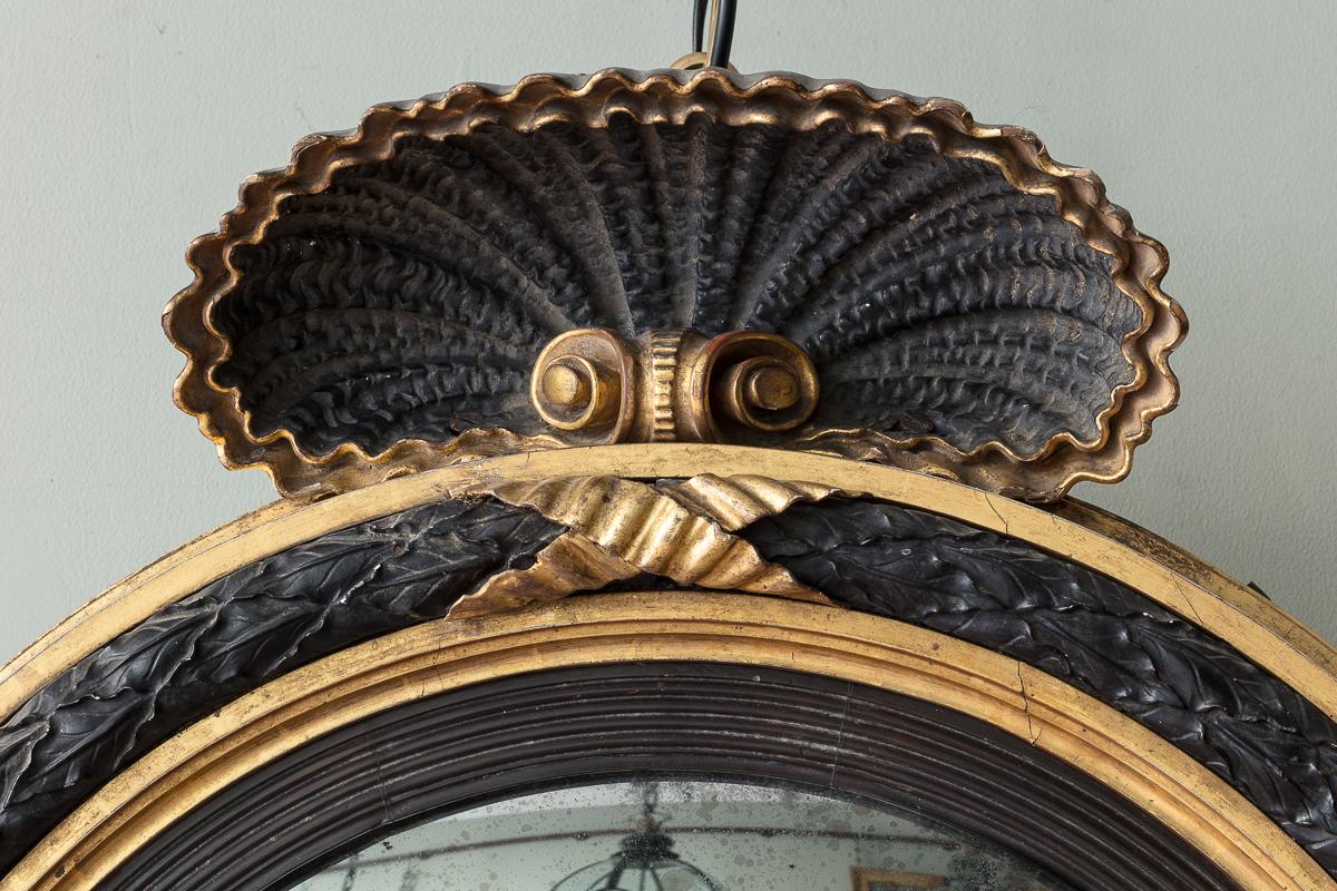 English A Regency Giltwood and Ebonised Convex Mirror