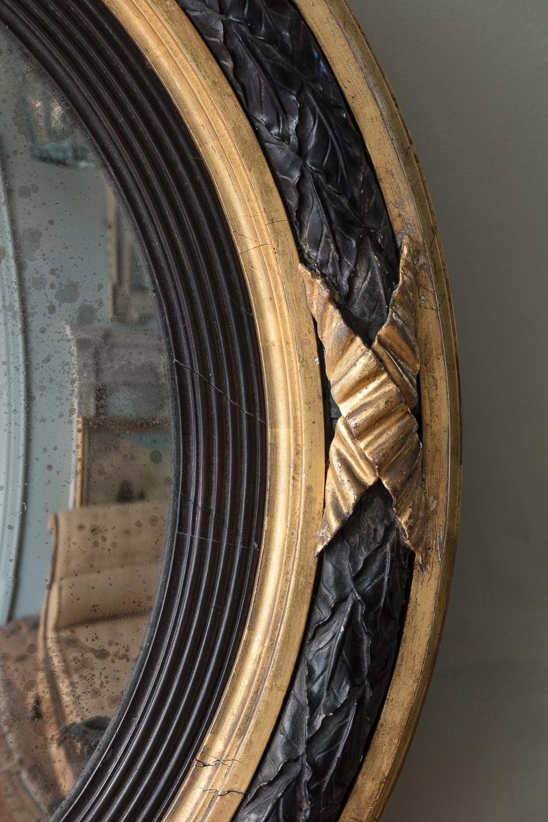 19th Century A Regency Giltwood and Ebonised Convex Mirror