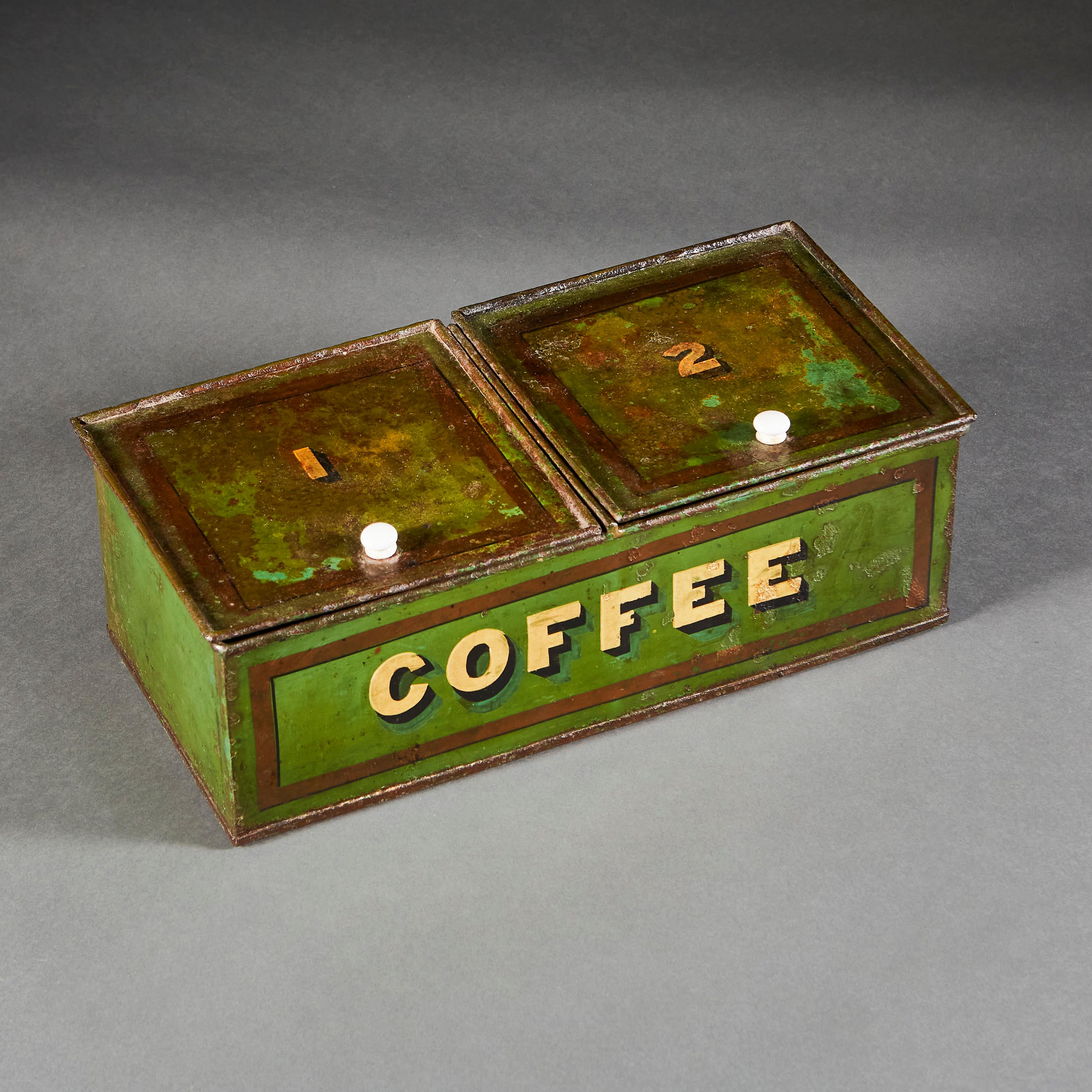 A mid-nineteenth century green tole coffee tin with two lidded apertures, labelled 1 and 2, with white porcelain handles.