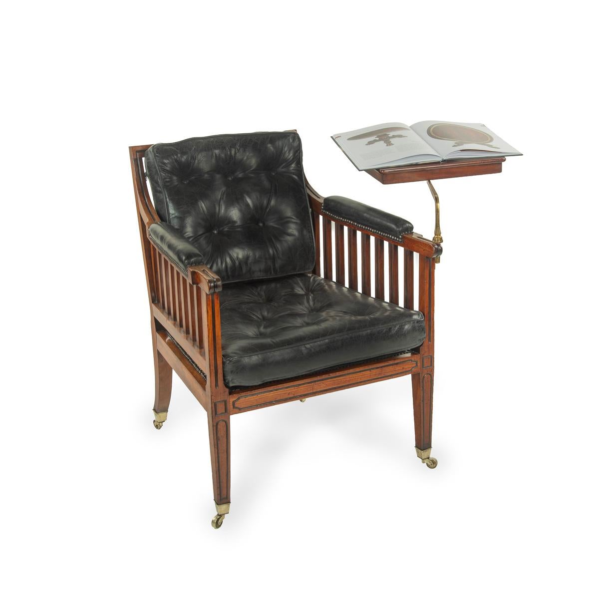 A Regency mahogany library reading chair, of rectangular form with slatted back and sides, with two deep buttoned cushions and padded elbow rests re-upholstered in distressed black leather, all four legs square in section, the front pair and seat