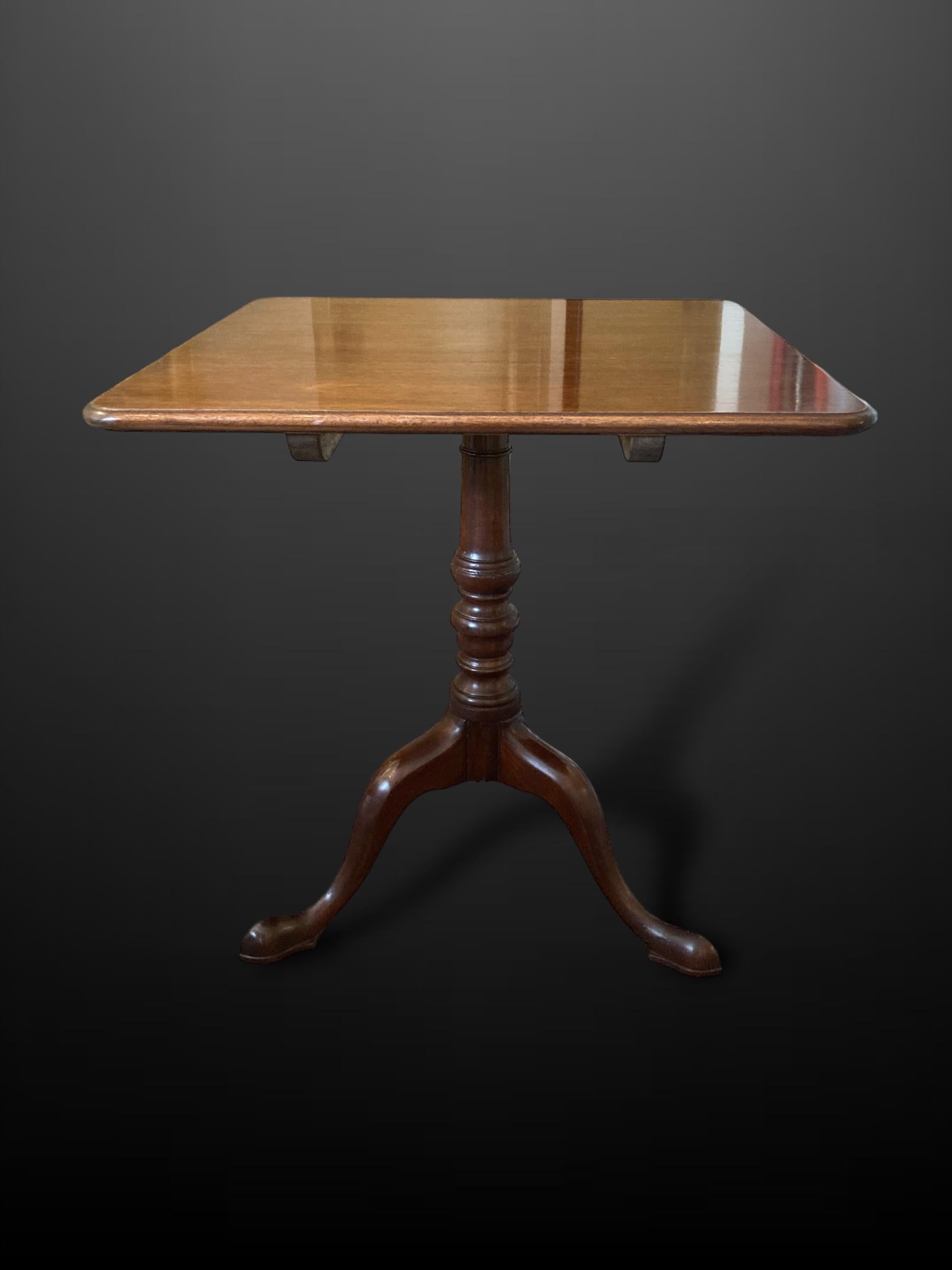 A Fine Regency Mahogany Tripod Table / Occasional Table

This 19th Century Regency Tripod Table / Occasional Table / Lamp Table features a square top and stands on an elegant turned pedestal with tripod splayed legs.