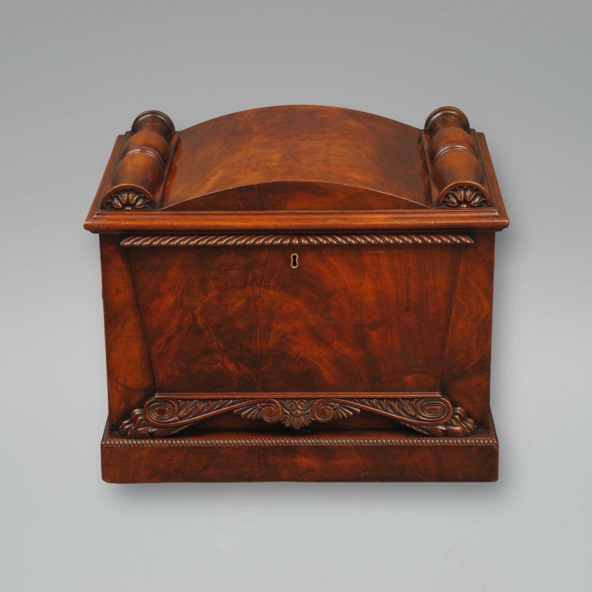 A good carved example of a Regency mahogany wine cooler of sarcophagus design with carved paw feet and flame veneers, in the manner of Thomas Hope.
Circa 1825