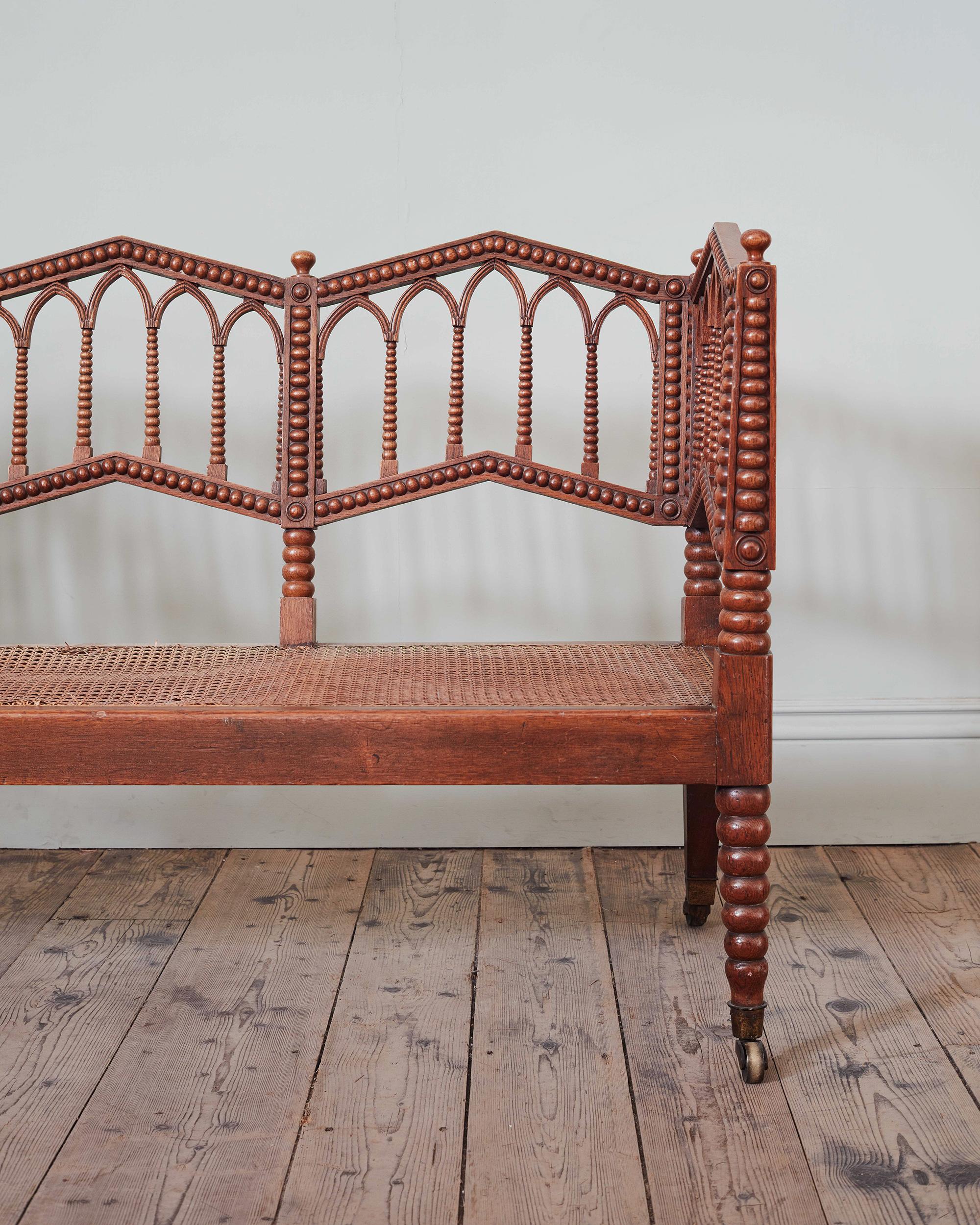 A Regency Oak & Caned Bobbin Hall Bench

Of unusual angular and characterful form, with gothic lines and bobbin shaping, with caned seat on brass casters.

Height: 90cm, 35 1/2″
Width: 151.5cm, 59 3/4″
Depth: 56cm, 22