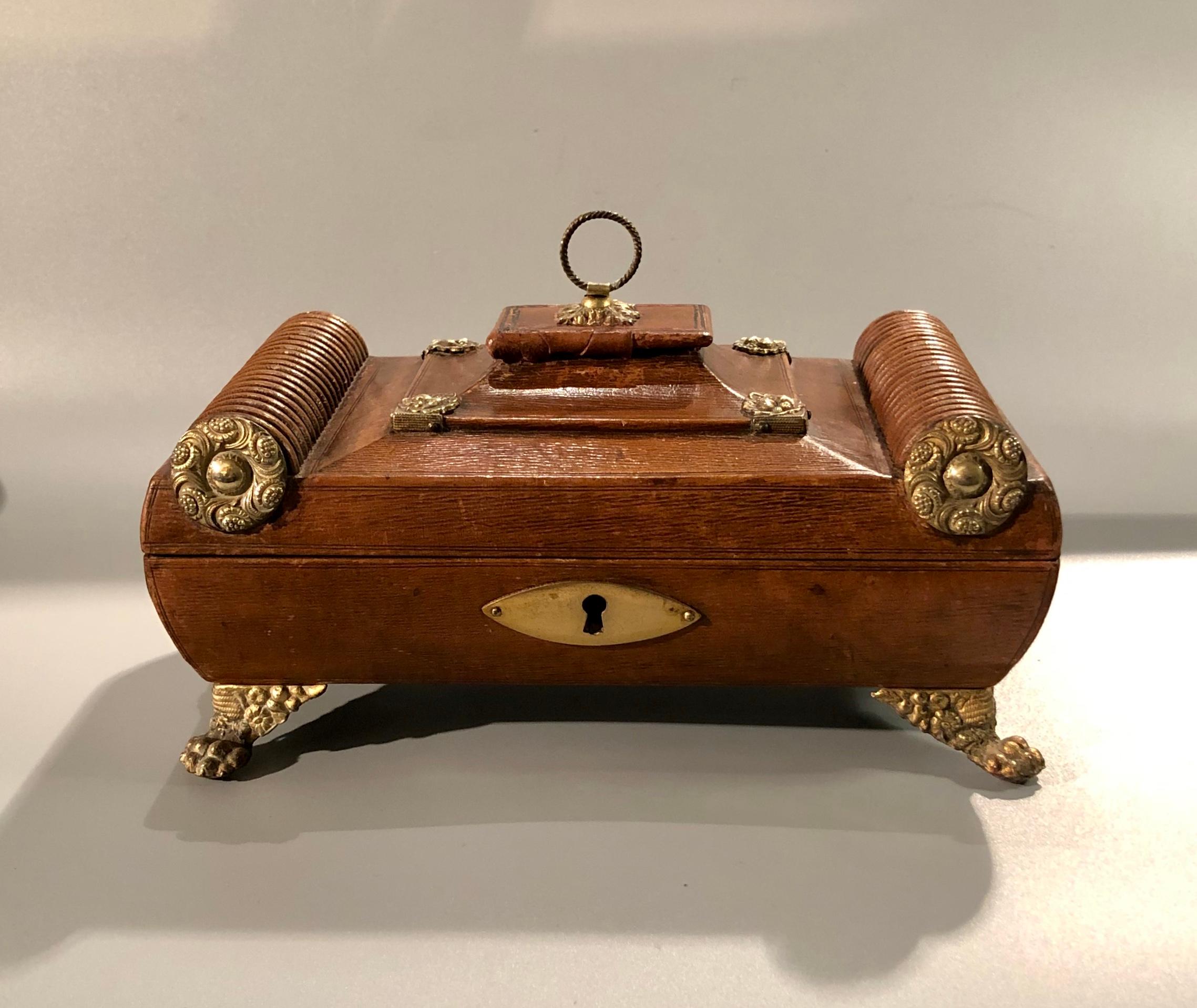A fine quality early 19th century Regency period leather sewing casket with gilt-brass mounts, paw feet and unusual balloon carrying handles retaining original interior.