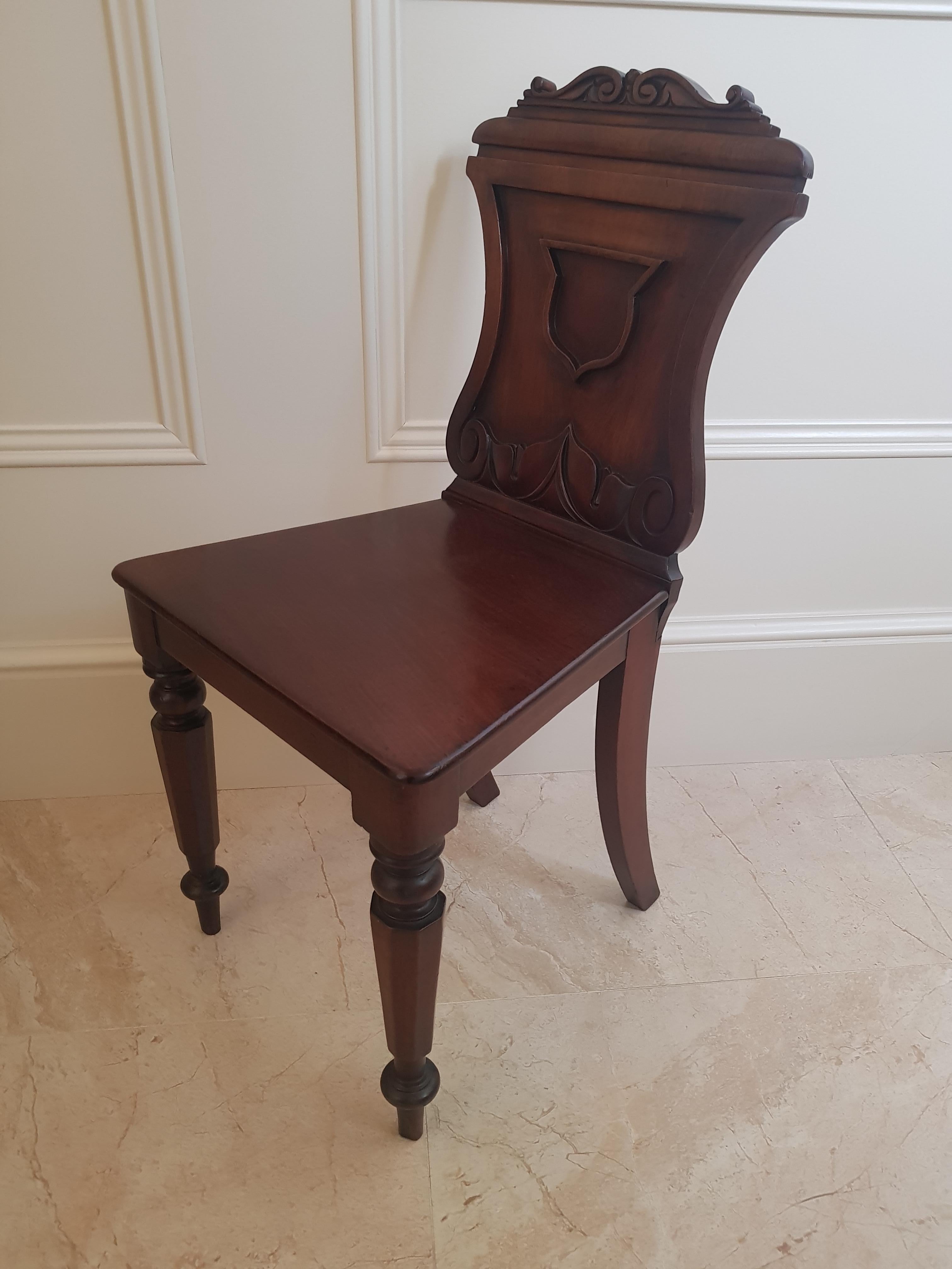 A Regency period mahogany hall chair, with excellent timbers and patina.