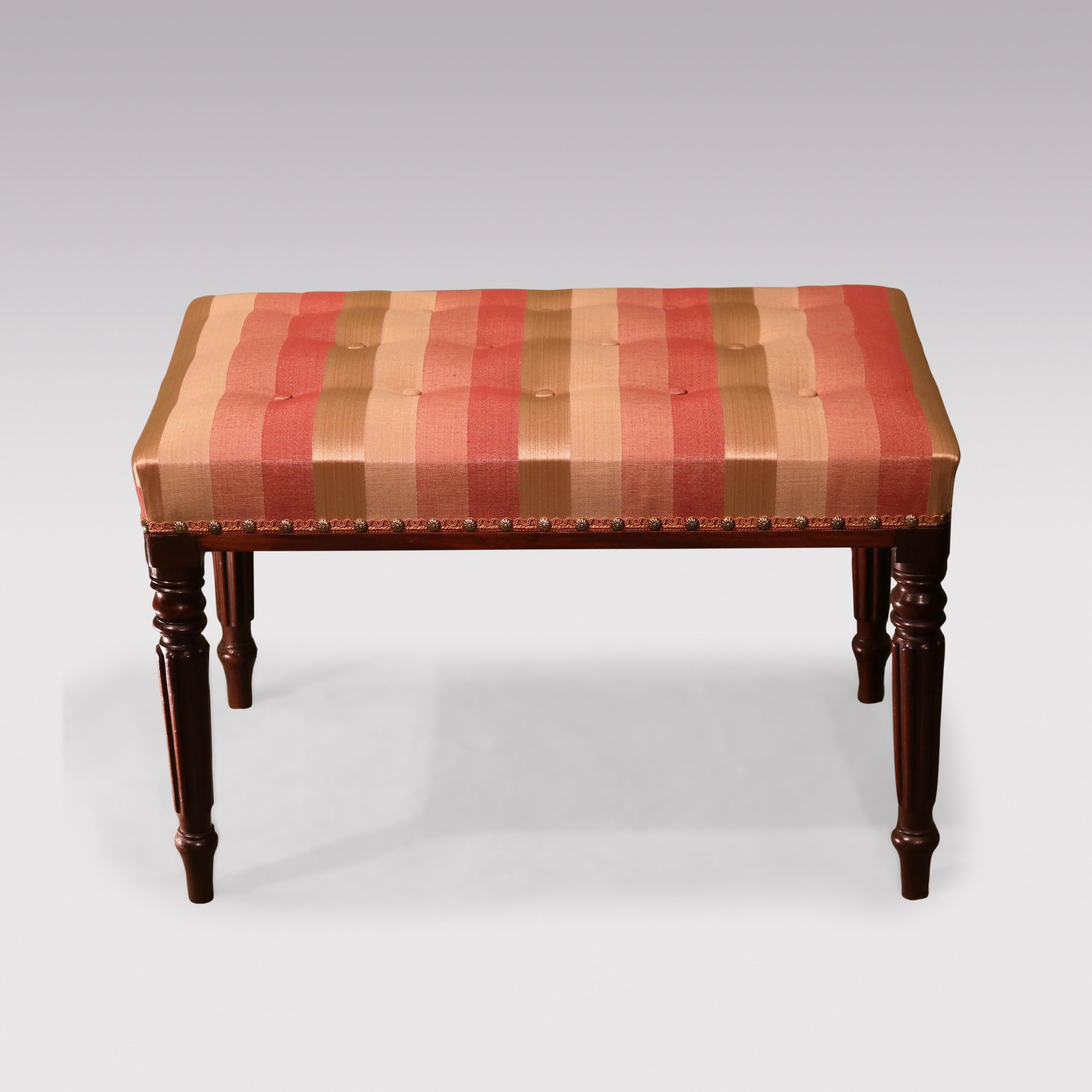 Early 19th Century Regency period mahogany Stool, having upholstered & buttoned rectangular top supported on turned reeded tapering legs.