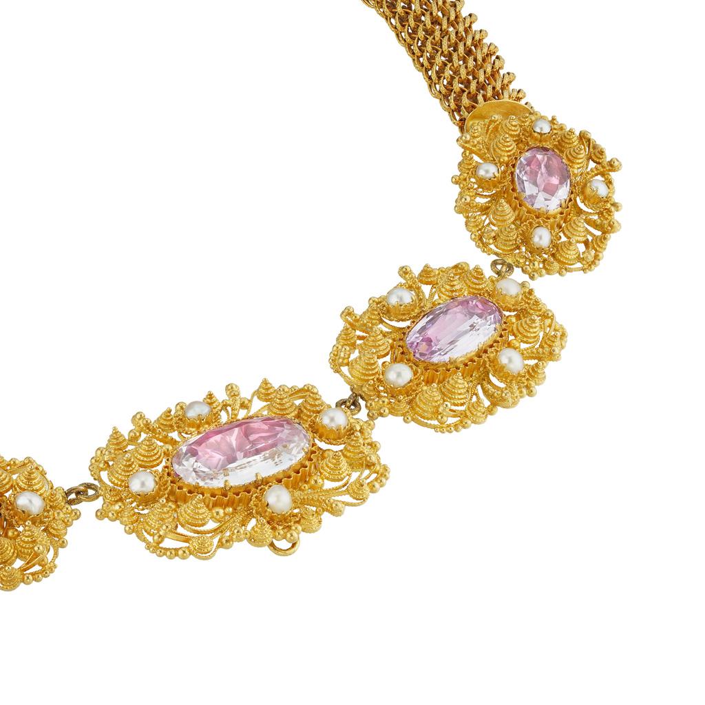 A Regency pink topaz cannetille necklace, the five graduating from the centre clusters of cannetile design, each centrally set with a pink oval shaped faceted foil-backed topaz, flanked with four pearls, all suspended by a yellow gold tubular mesh
