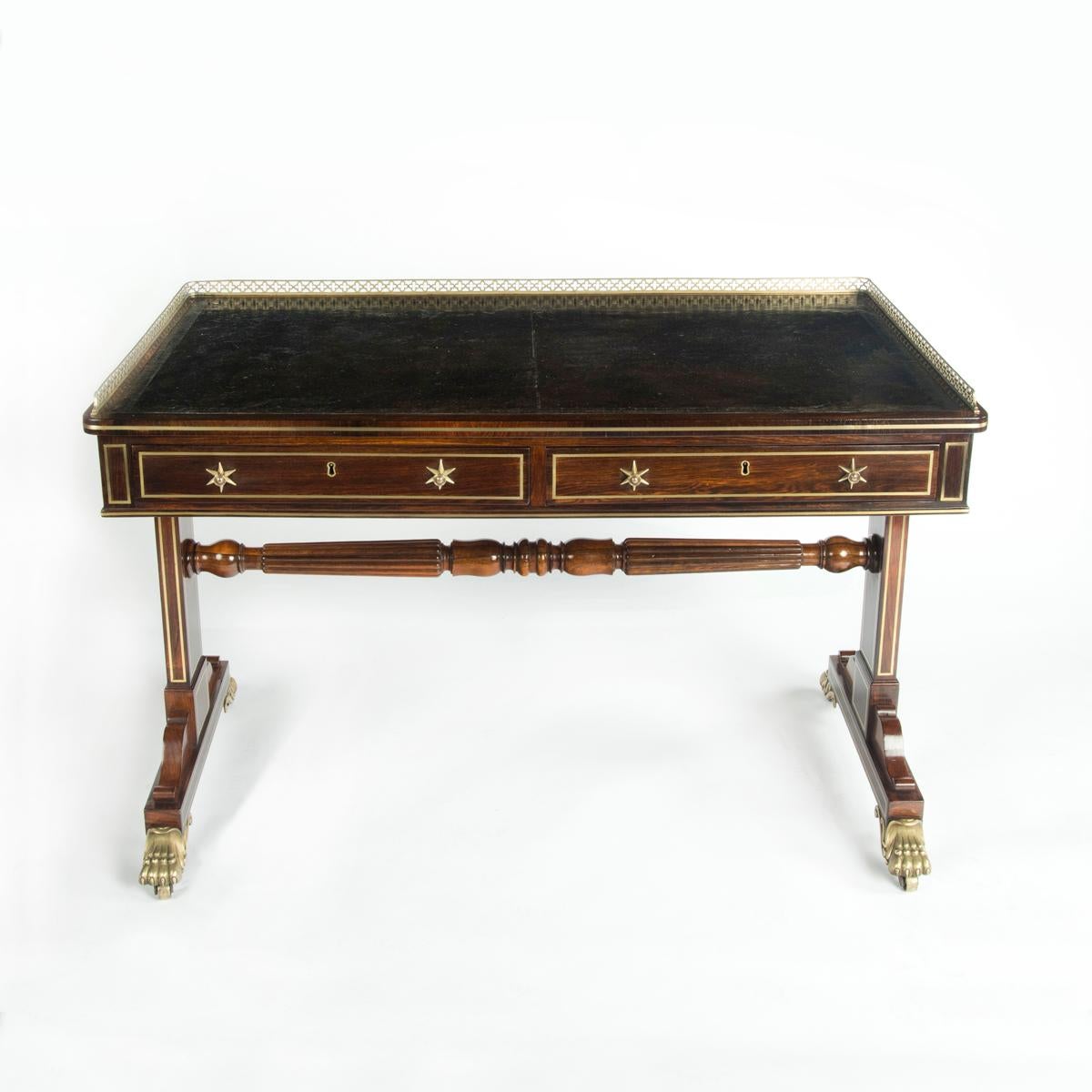 A Regency rosewood free standing end support writing table, by Gillows, the leather inset rectangular top with a brass gallery above two frieze drawers on one side and two dummy drawers on the other, raised on flat pedestal ends joined by a turned