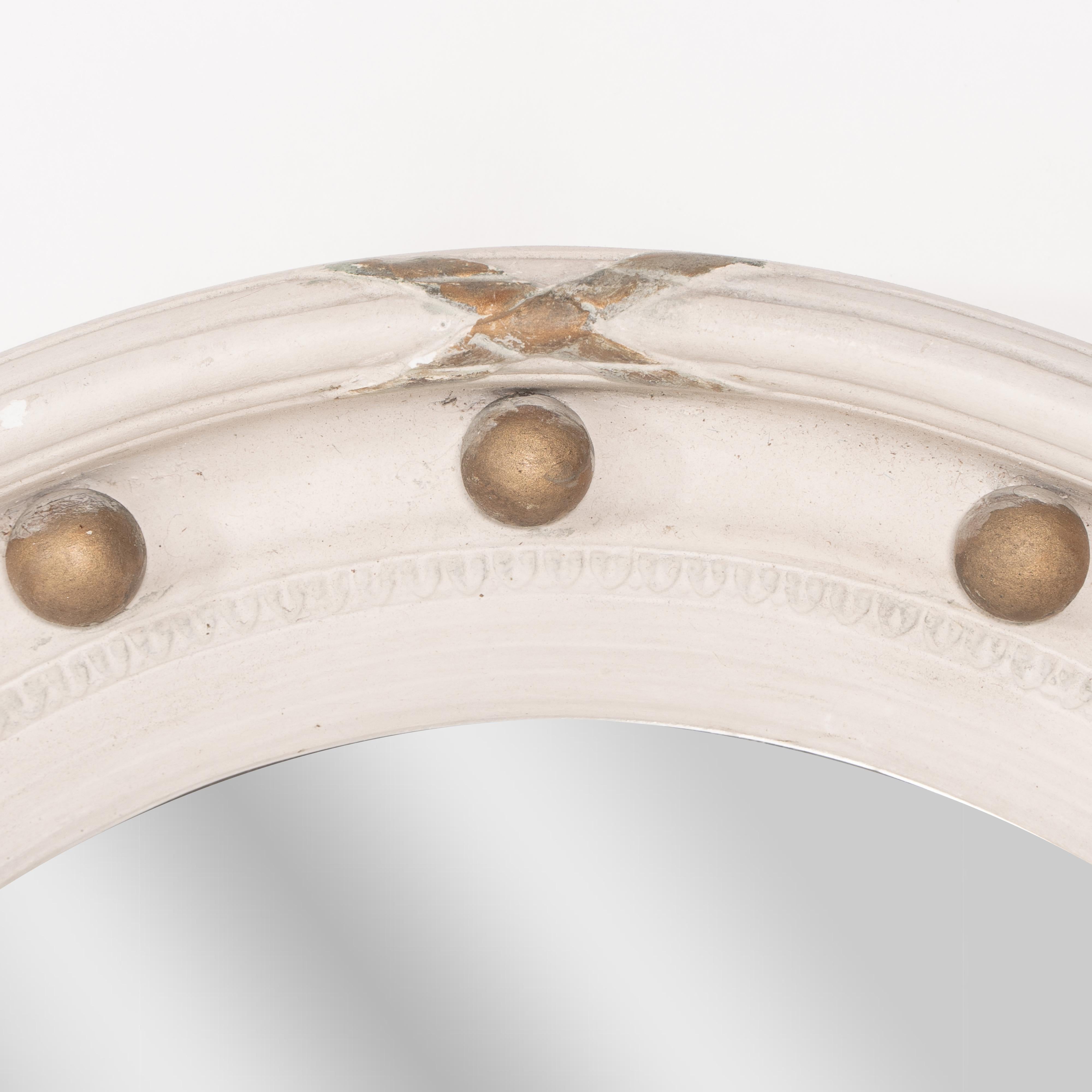 Mirror A Regency style circular convex mirror with ball and ribbon decoration For Sale