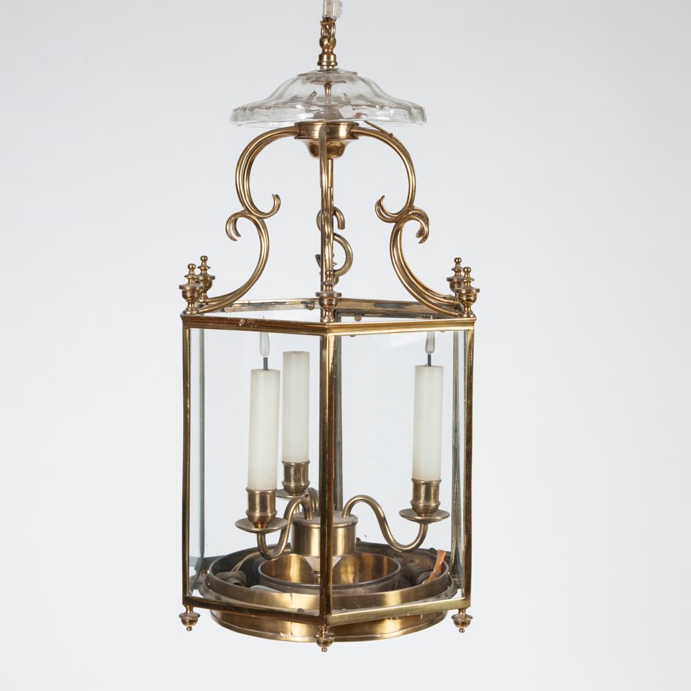 A regency style glazed brass hexagonal hall lantern, with glass canopy and 3 internal lights.

The lower ring has provision for three up-lights.