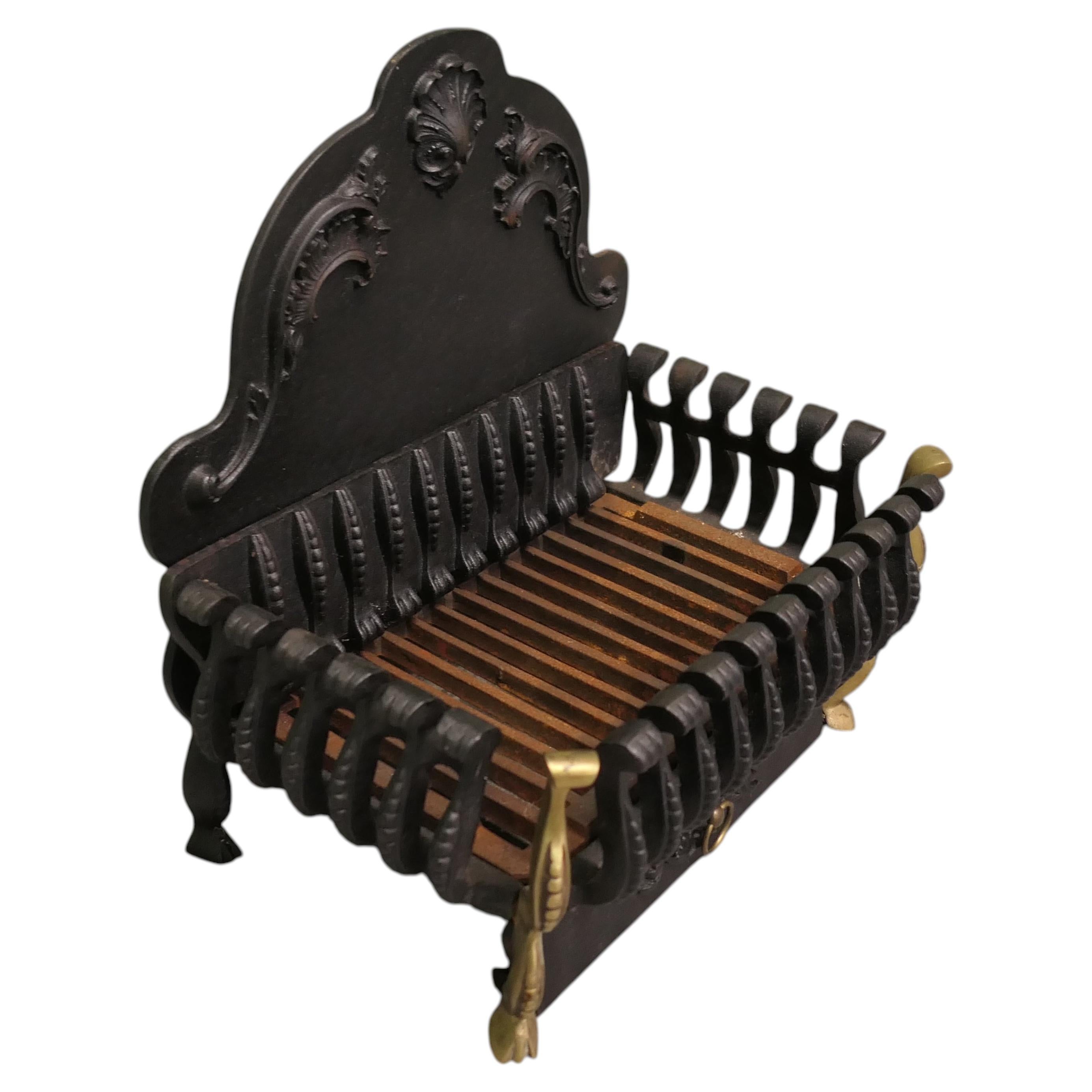 A Regency Style Iron Fire Grate The fire has a decorative high shaped back, i