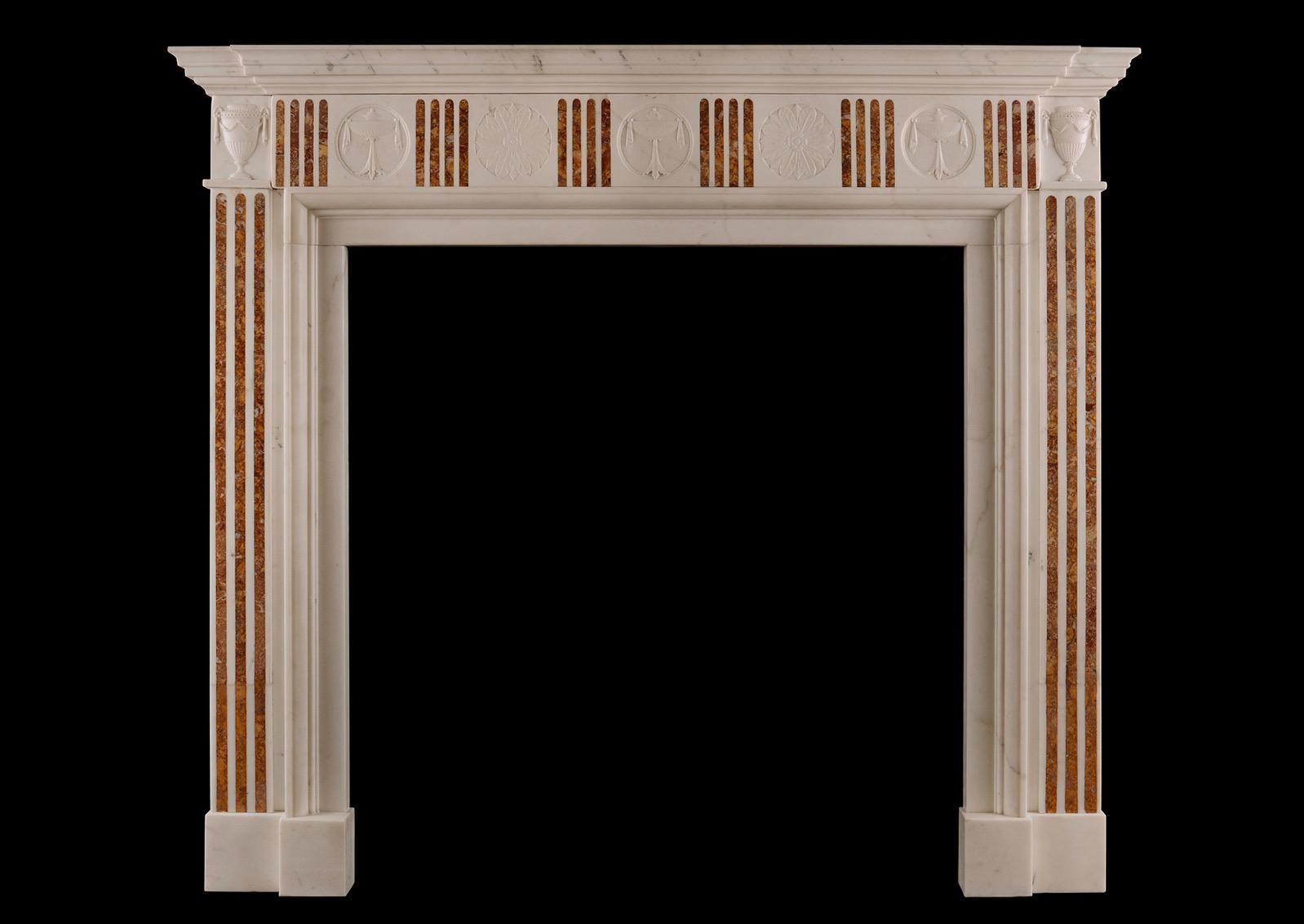 A Regency style fireplace in Statuary marble antique fireplace with Sienna Brocatelle inlay. The fluted jambs surmounted by urns of classical form. The frieze with matching flutes, interspersed with rosettes with carved urns and foliage. English,