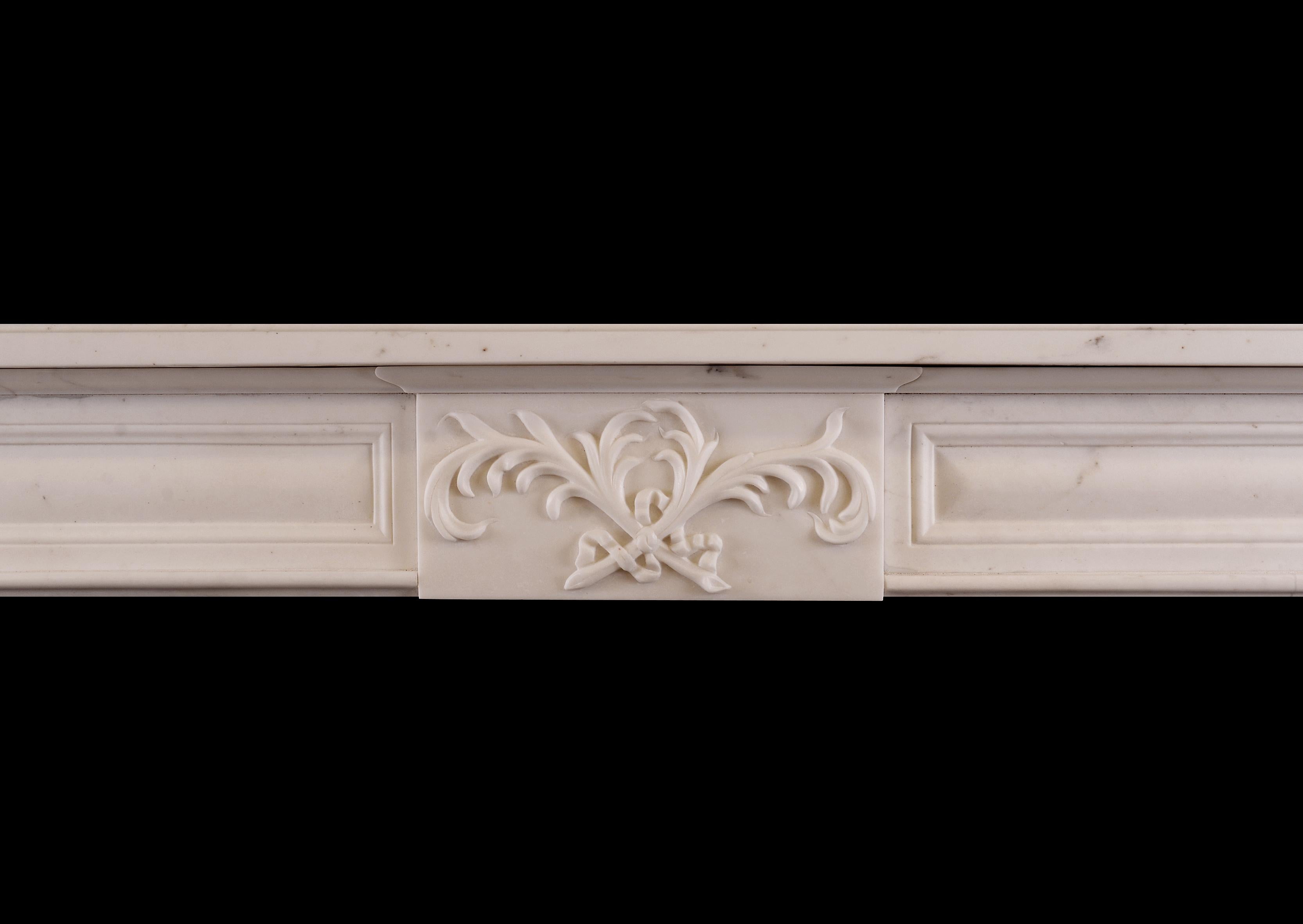 A late Regency style statuary white marble fireplace. The panelled jambs surmounted by square panelled end blockings. The frieze with centre plaque featuring cross-banded foliage, flanked by matching panels. Plain shelf above. English, 19th