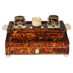 A Regency tortoiseshell and ivory desk set
