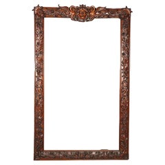 A relief carved mahogany frame (with added mirror)