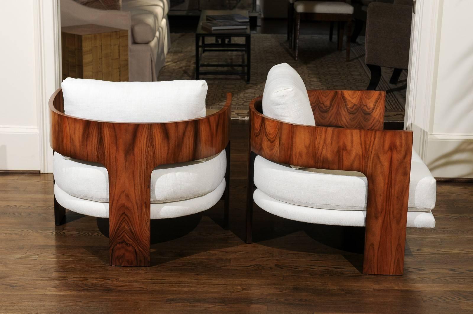 An magnificent restored pair of modern Emperor's lounge or club chairs by Milo Baughman for Thayer Coggin, dated 1966. Fabulous stout molded plywood frame veneered in stunning bookmatched figured Walnut. Stellar design, material selection and