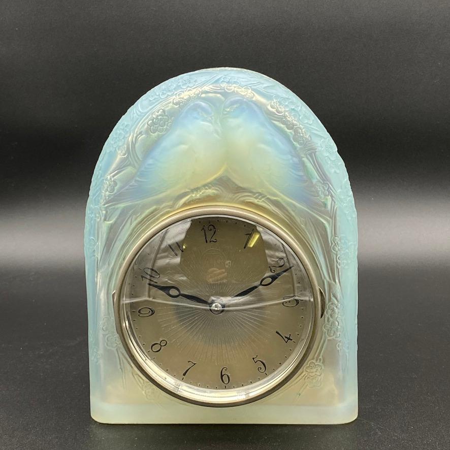 R. Lalique has designed several clocks.

Some for his own galleries, some for classical clock makers who wanted to introduce glass in their window displays.

This clock was made by Lalique for the famous Art Deco clock maker ATO who made