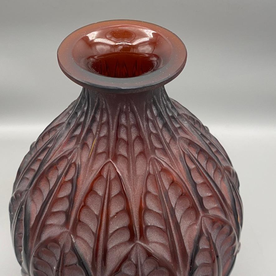 The Malesherbes vase was made by R.Lalique in 1927 in white glass.

The model is the  study of the Art Deco interpretation of leaves .

This example is in brown glass with a white acid patina .

The signature is in script letters .

It became soon