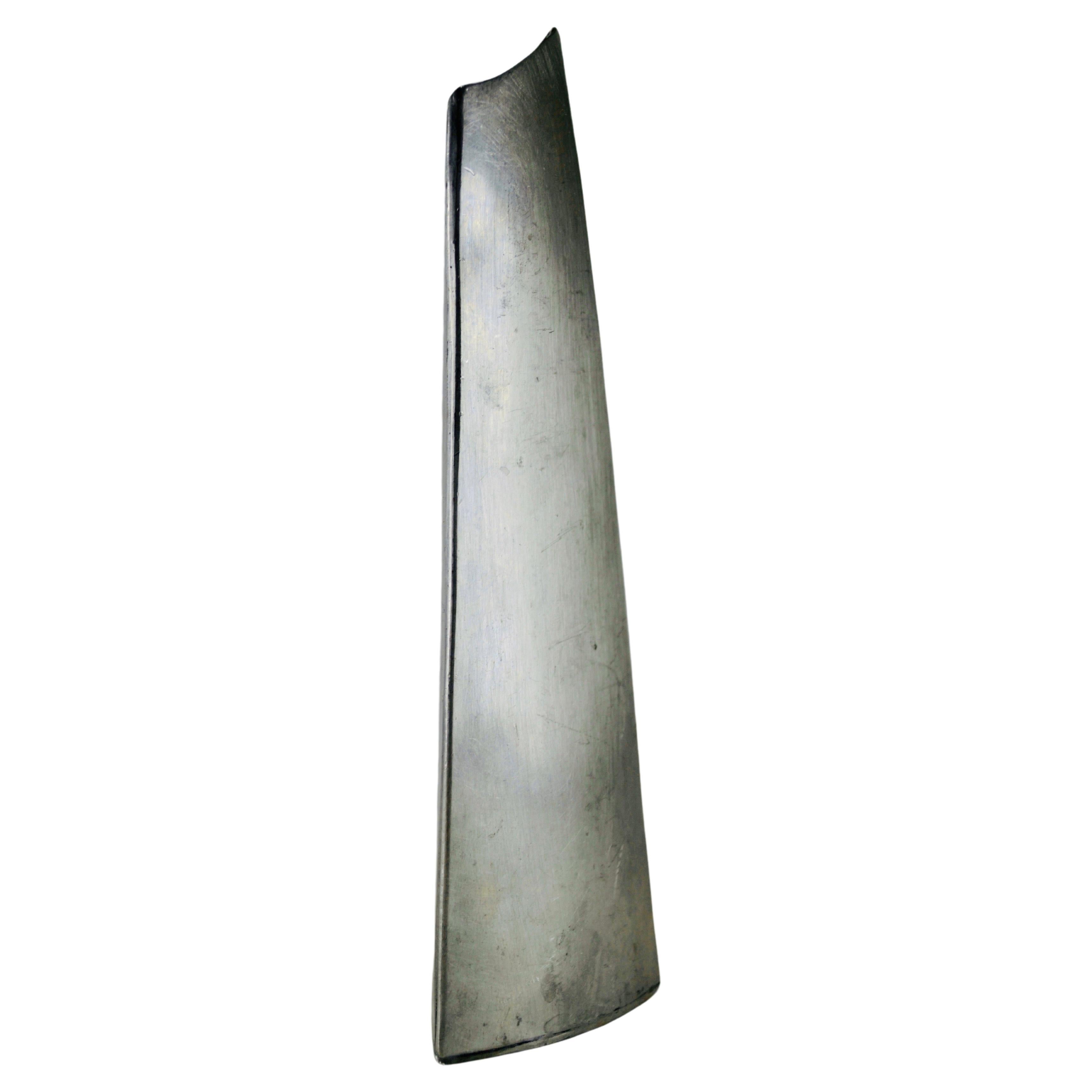 A magnificent repoussé stainless steel vase, a unique piece from the 1970s that combines the elegance of vintage design with the durability of stainless steel. This freeform vase is a timeless work of art, crafted using the traditional repoussé