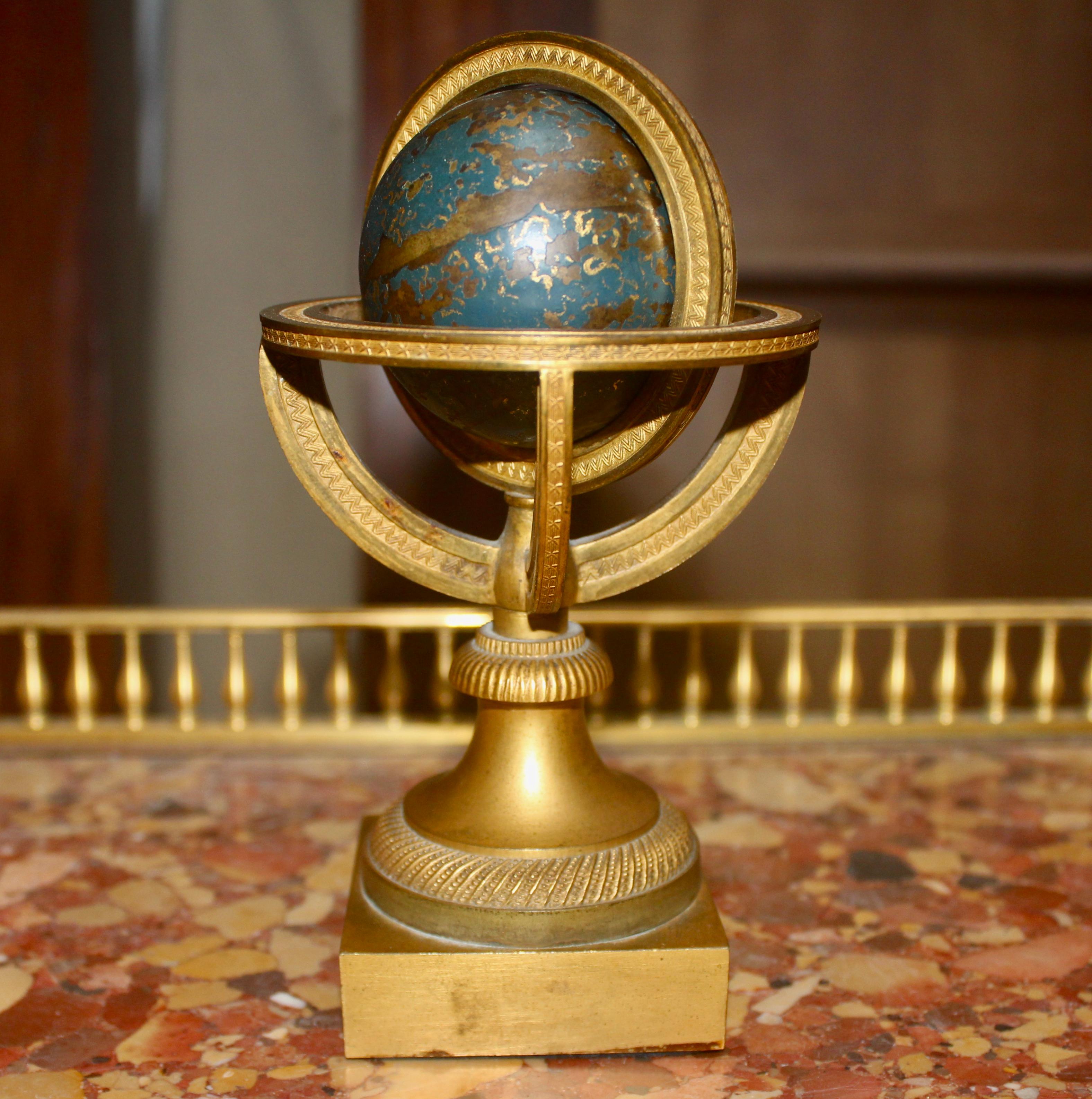 Enameled Restauration Gilded and Epargne Armillary Sphere and Paperweight, circa 1830